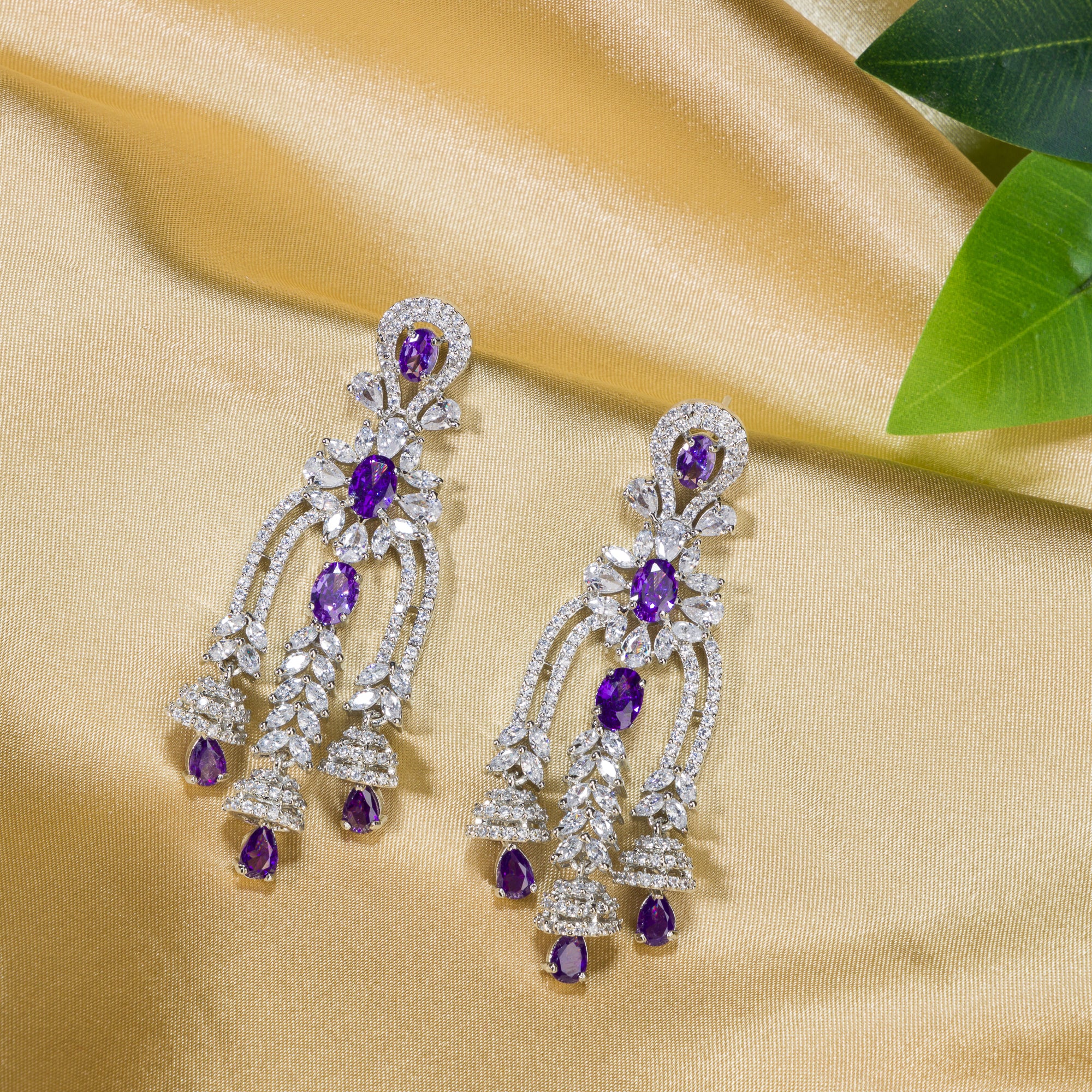 1. "Blue zircon dangler earrings shimmer with a captivating, deep sparkle for a bold look."