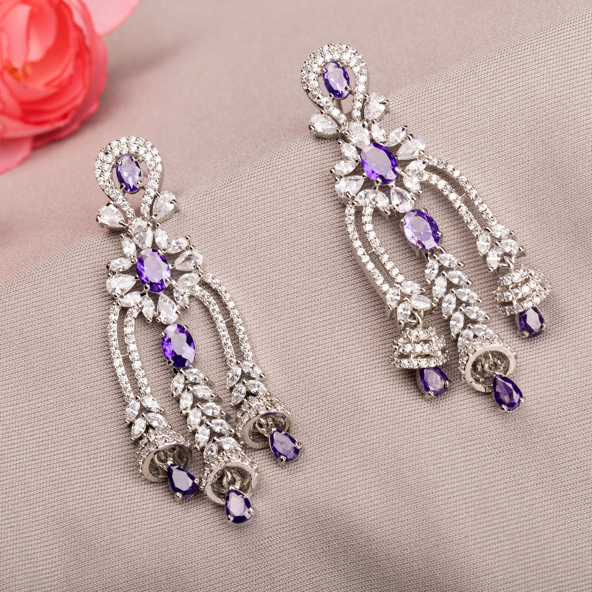 1. "Blue zircon dangler earrings shimmer with a captivating, deep sparkle for a bold look."