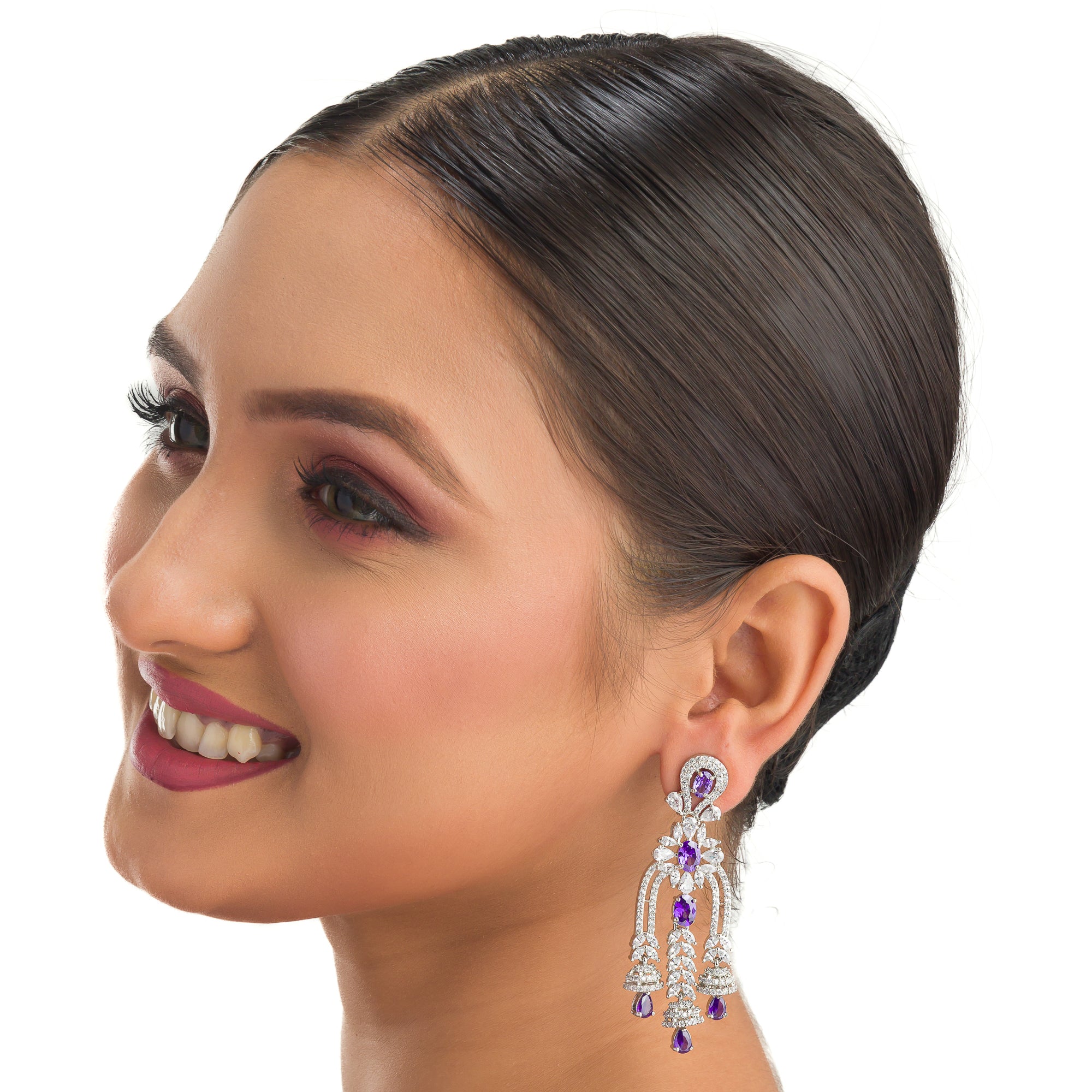 1. "Blue zircon dangler earrings shimmer with a captivating, deep sparkle for a bold look."