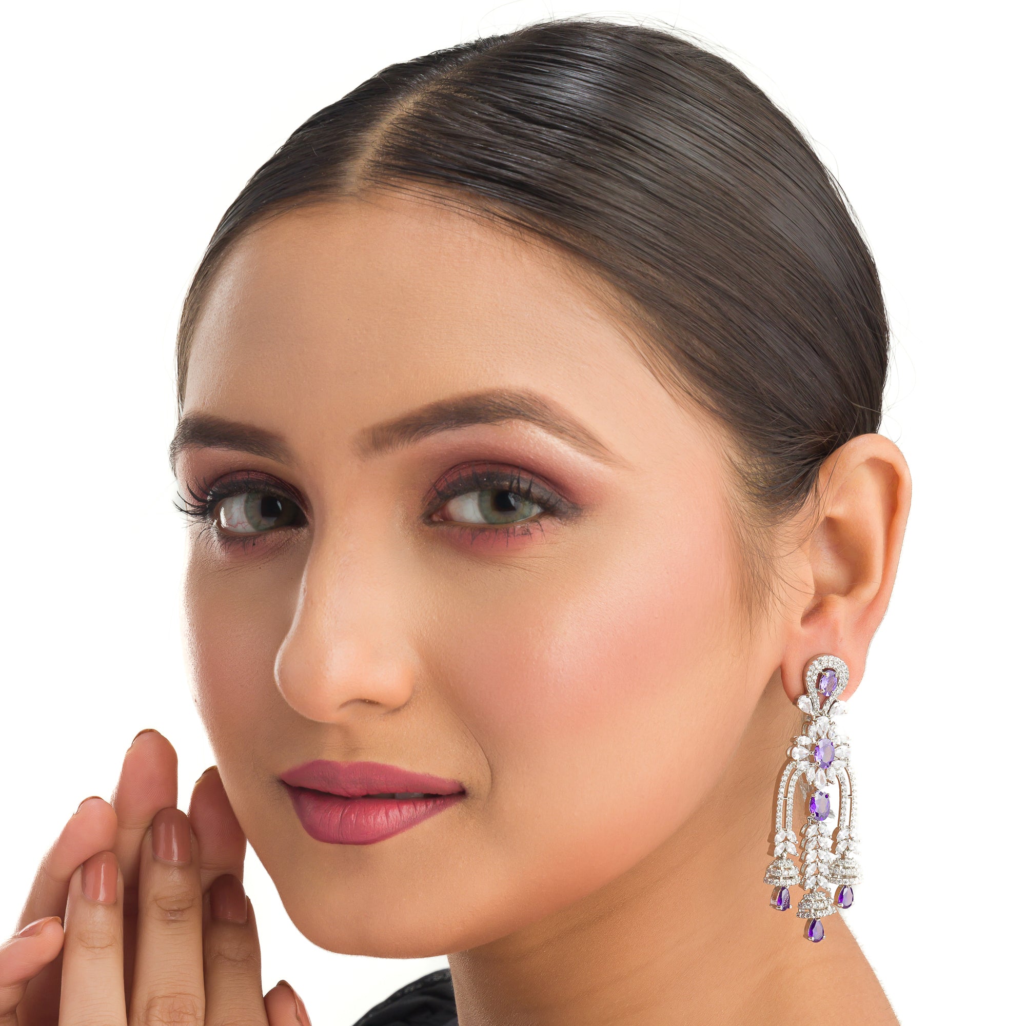 1. "Blue zircon dangler earrings shimmer with a captivating, deep sparkle for a bold look."