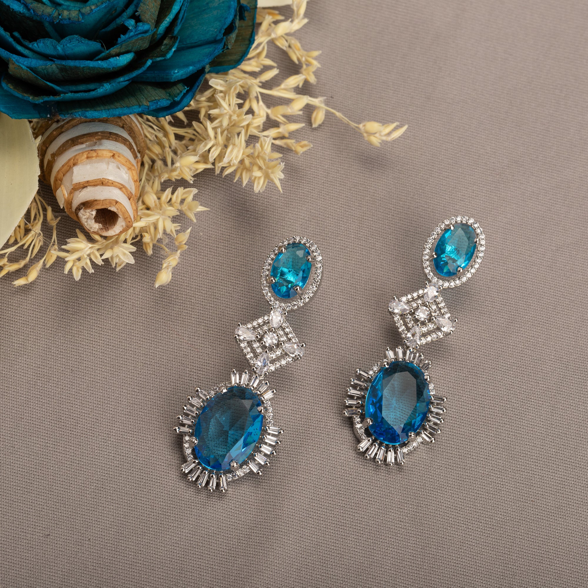 "Blue zircon dangler earrings exude a captivating sparkle, perfect for any party."