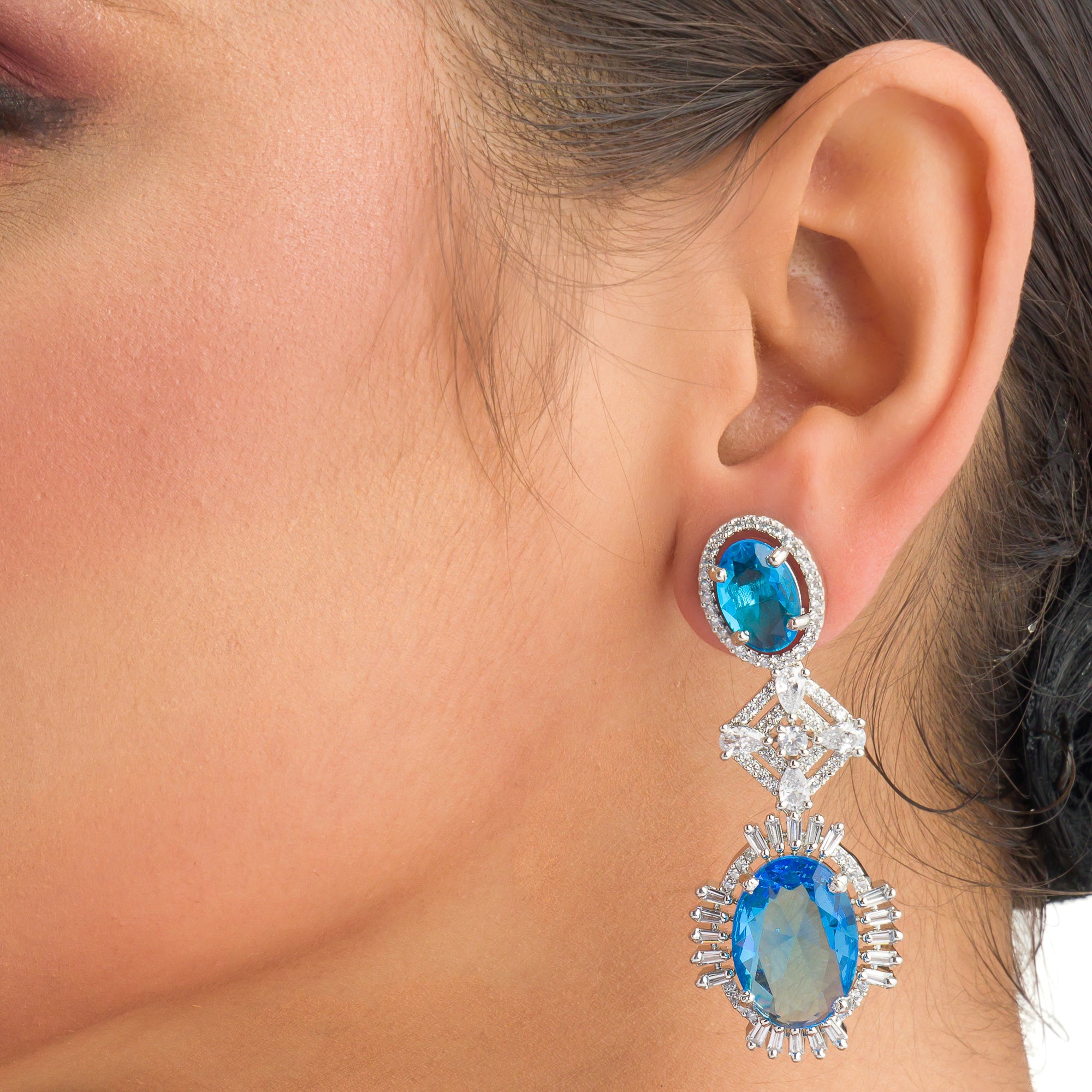 "Blue zircon dangler earrings exude a captivating sparkle, perfect for any party."