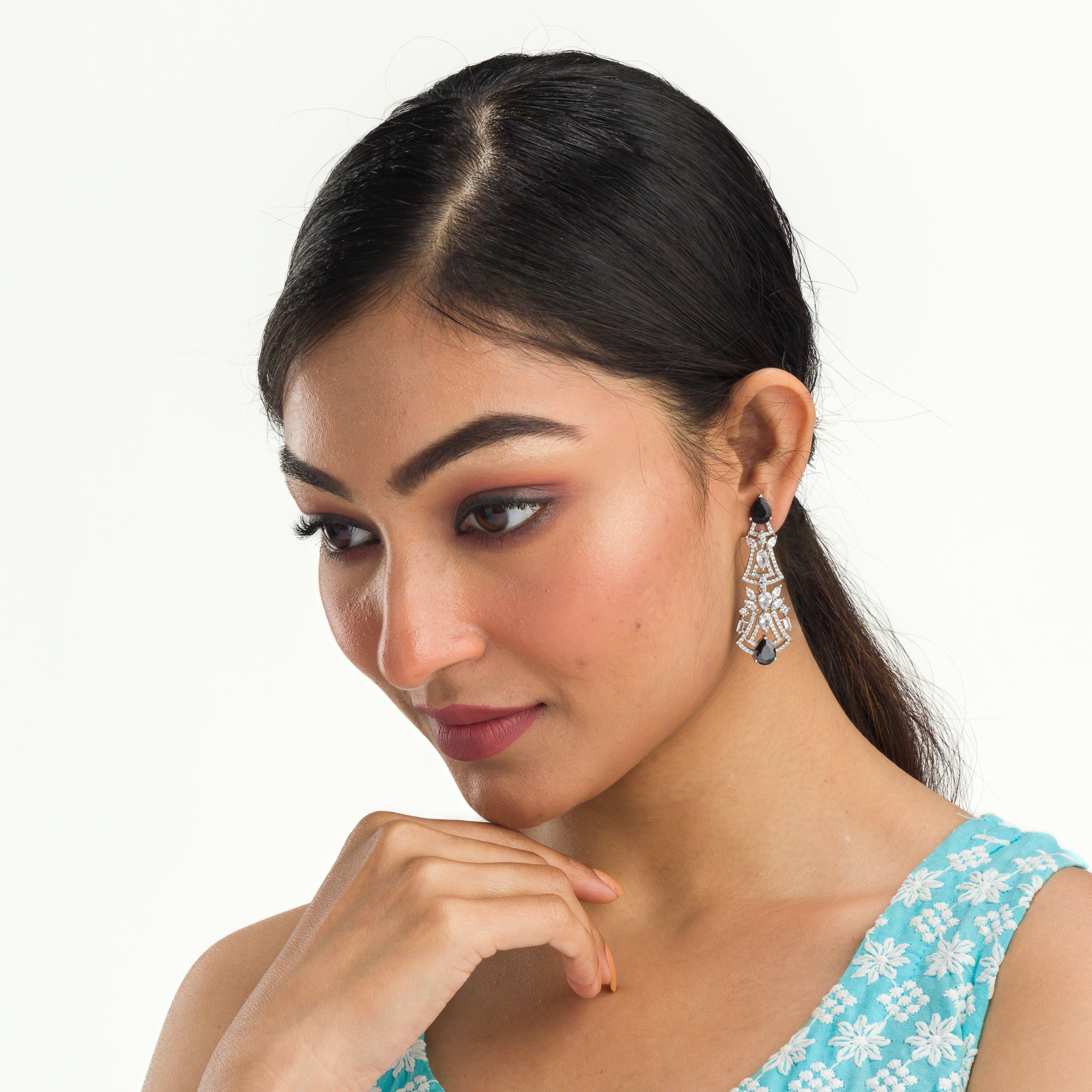 1. "Zircon earrings with black accents create a dramatic, elegant contrast."