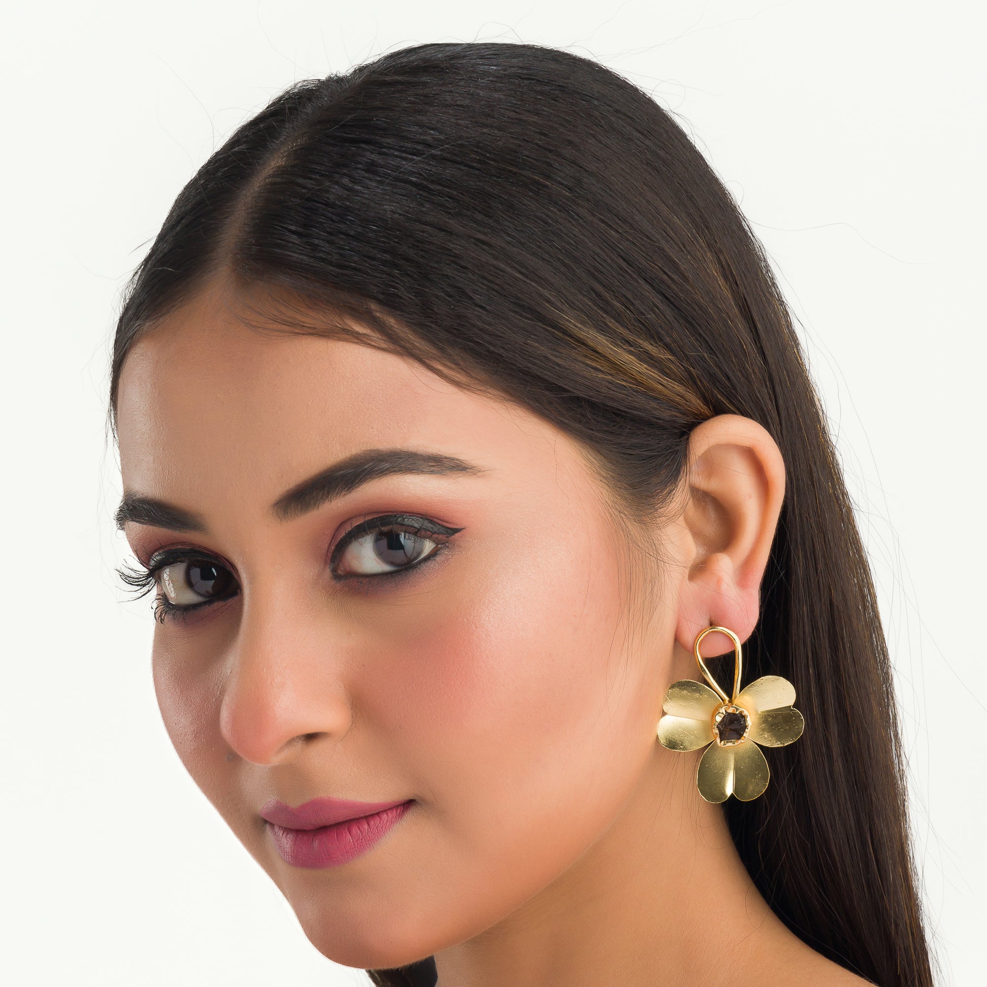 "Gold-tone flower studs with uncut stones offer timeless elegance for any occasion."