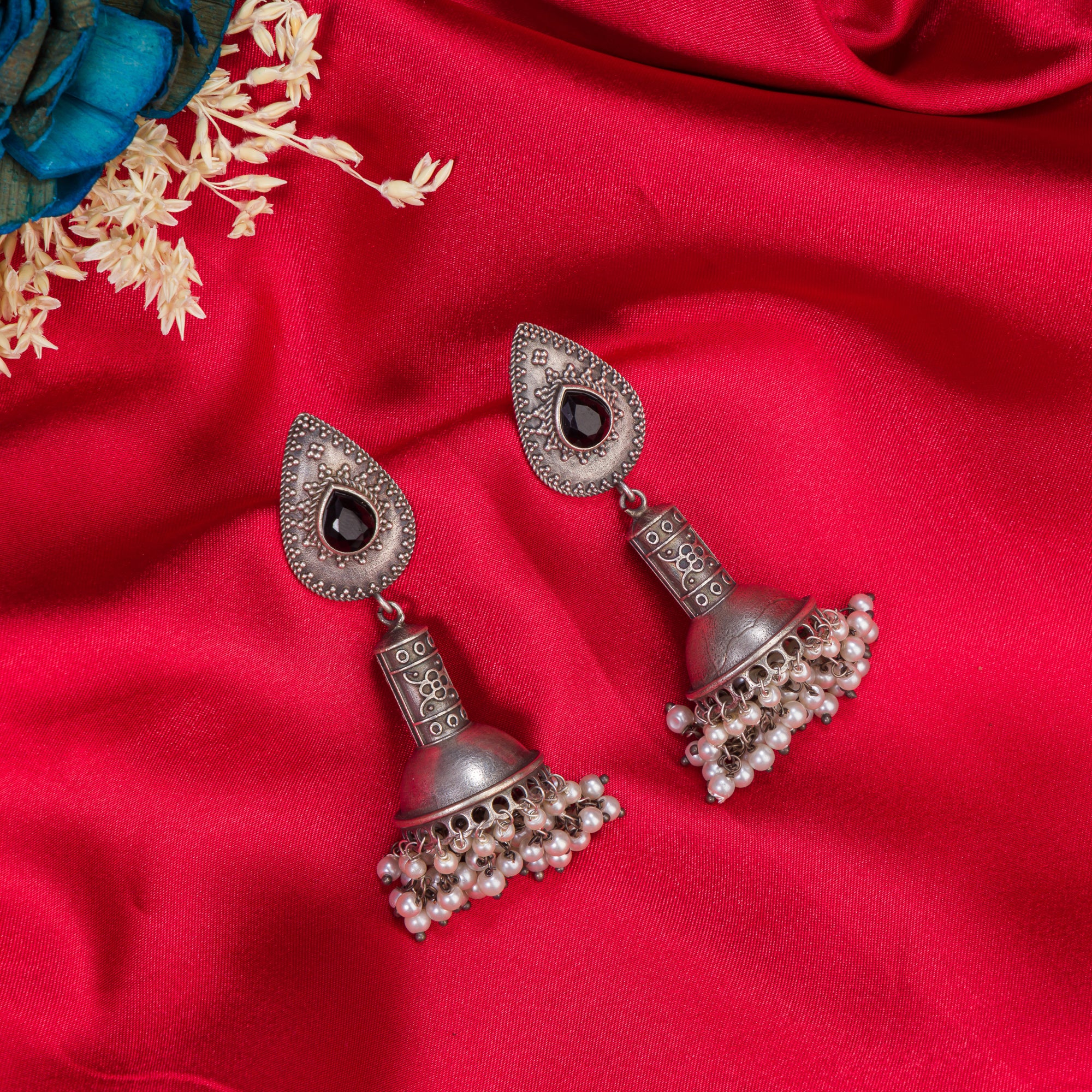 "Oxidized jhumka with black stone delivers a striking vintage allure for a timeless style."
