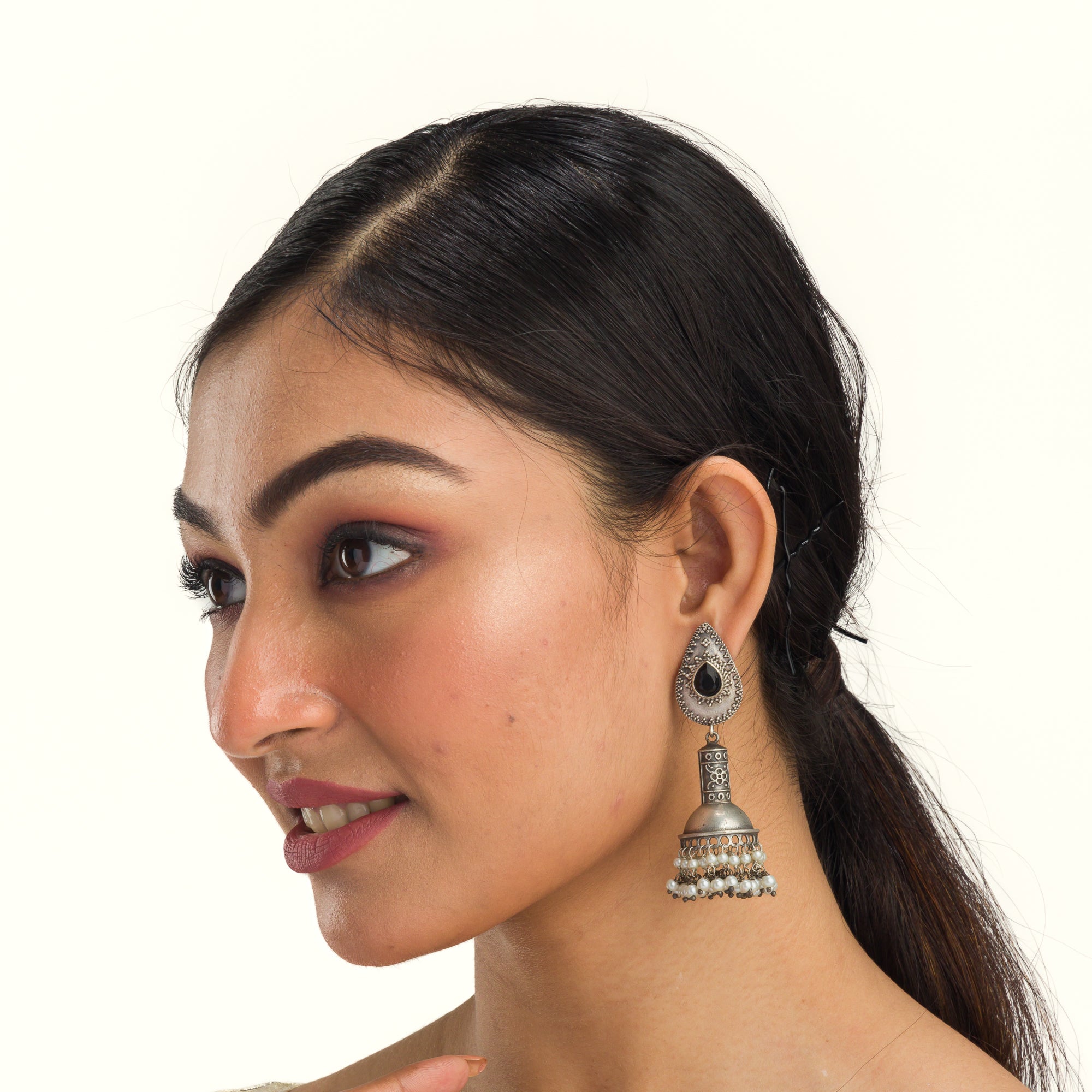 "Oxidized jhumka with black stone delivers a striking vintage allure for a timeless style."