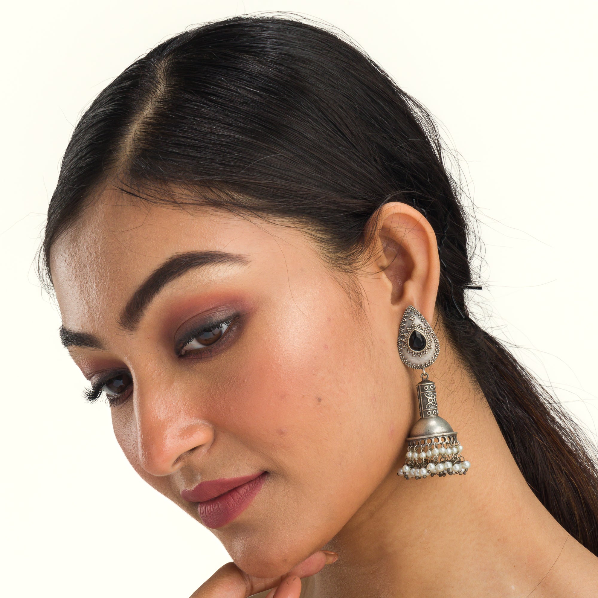 "Oxidized jhumka with black stone delivers a striking vintage allure for a timeless style."