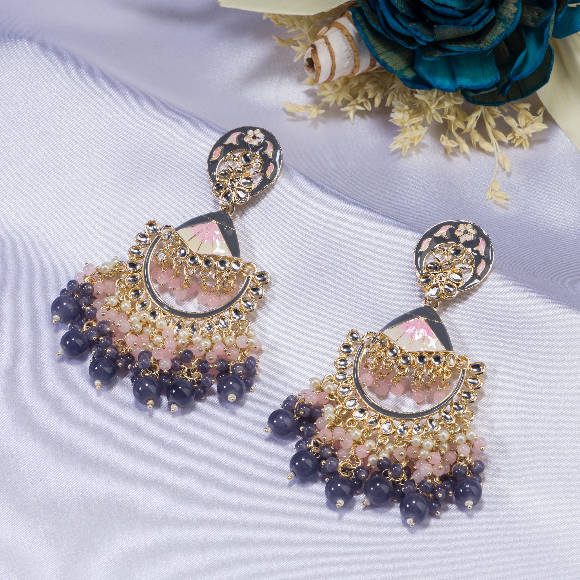 "Pink and white zircon jhumkas blend vibrant color with timeless elegance for a stunning look."