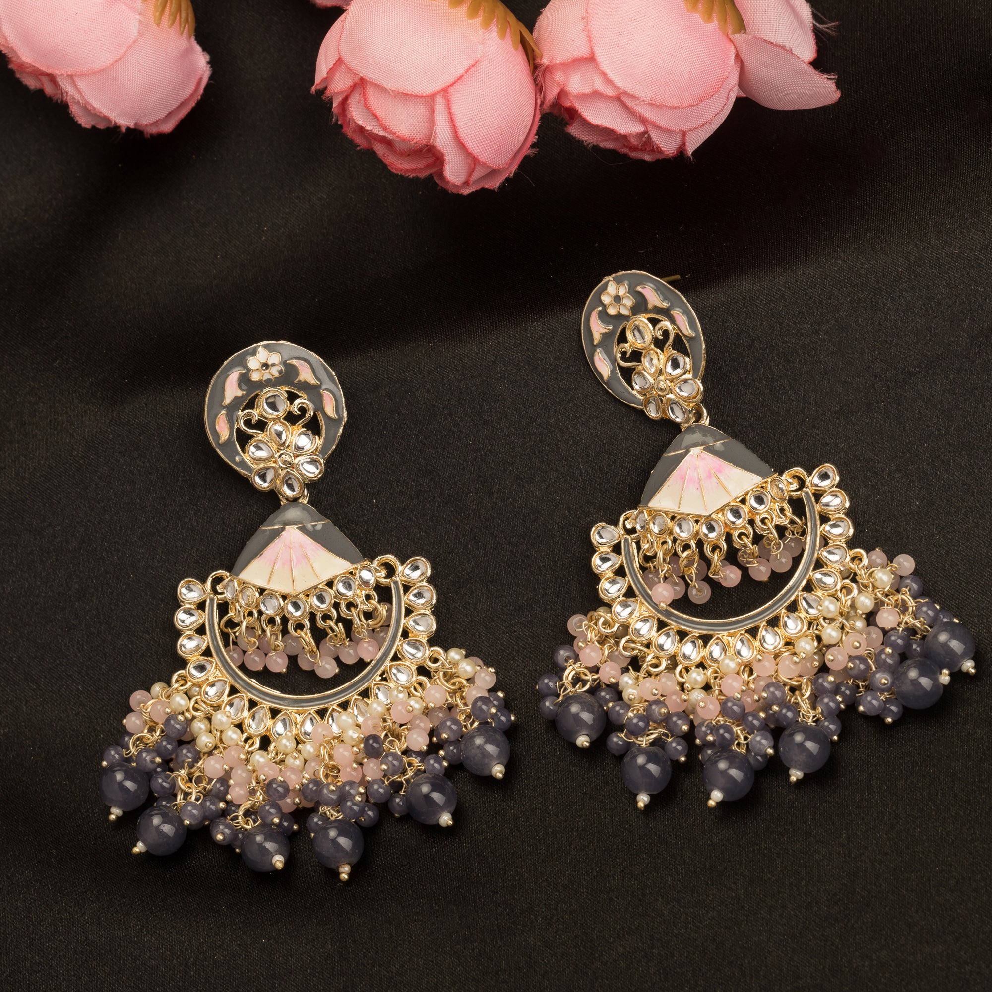 "Pink and white zircon jhumkas blend vibrant color with timeless elegance for a stunning look."