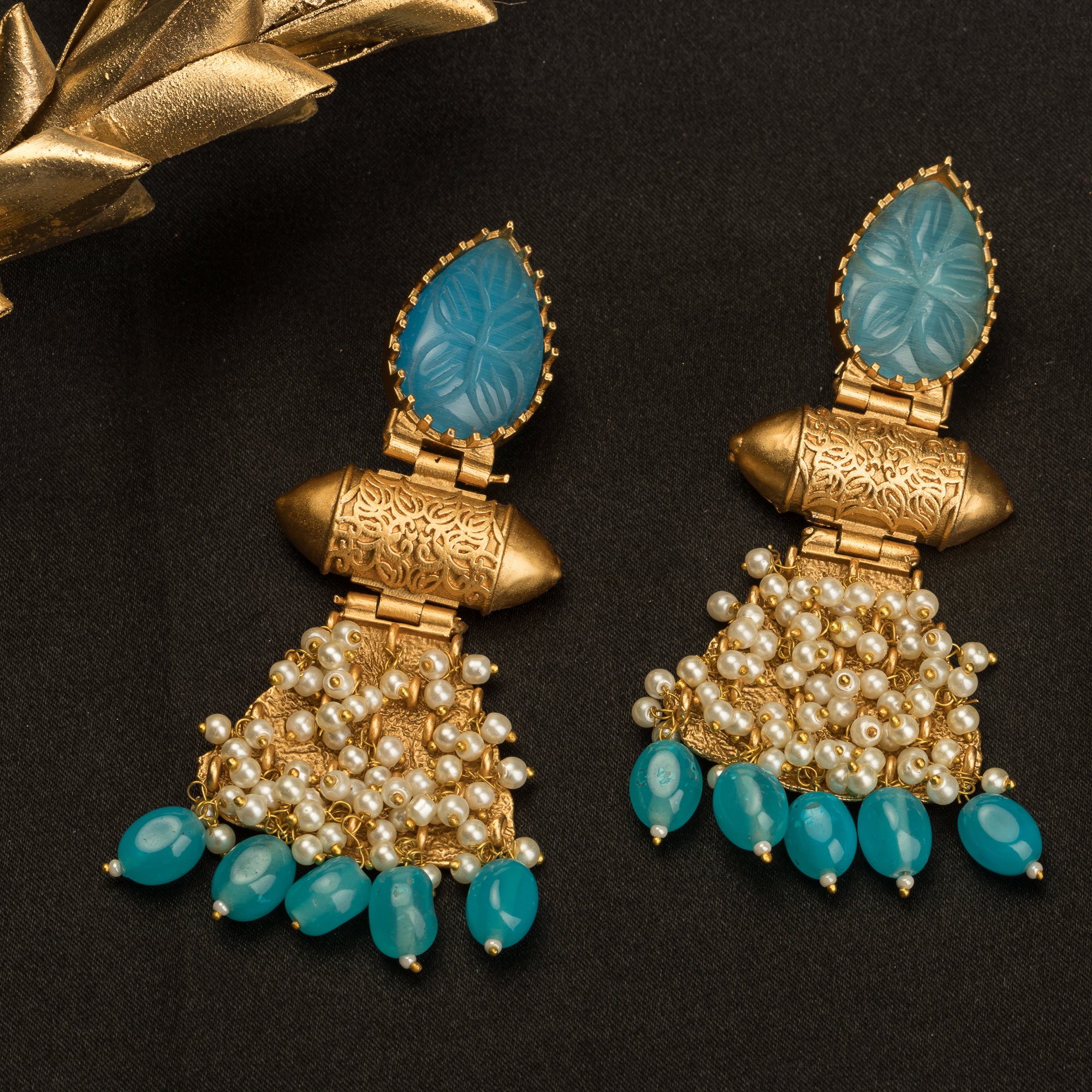 "Blue earrings with gold-tone polish combine vibrant color and a sophisticated finish."