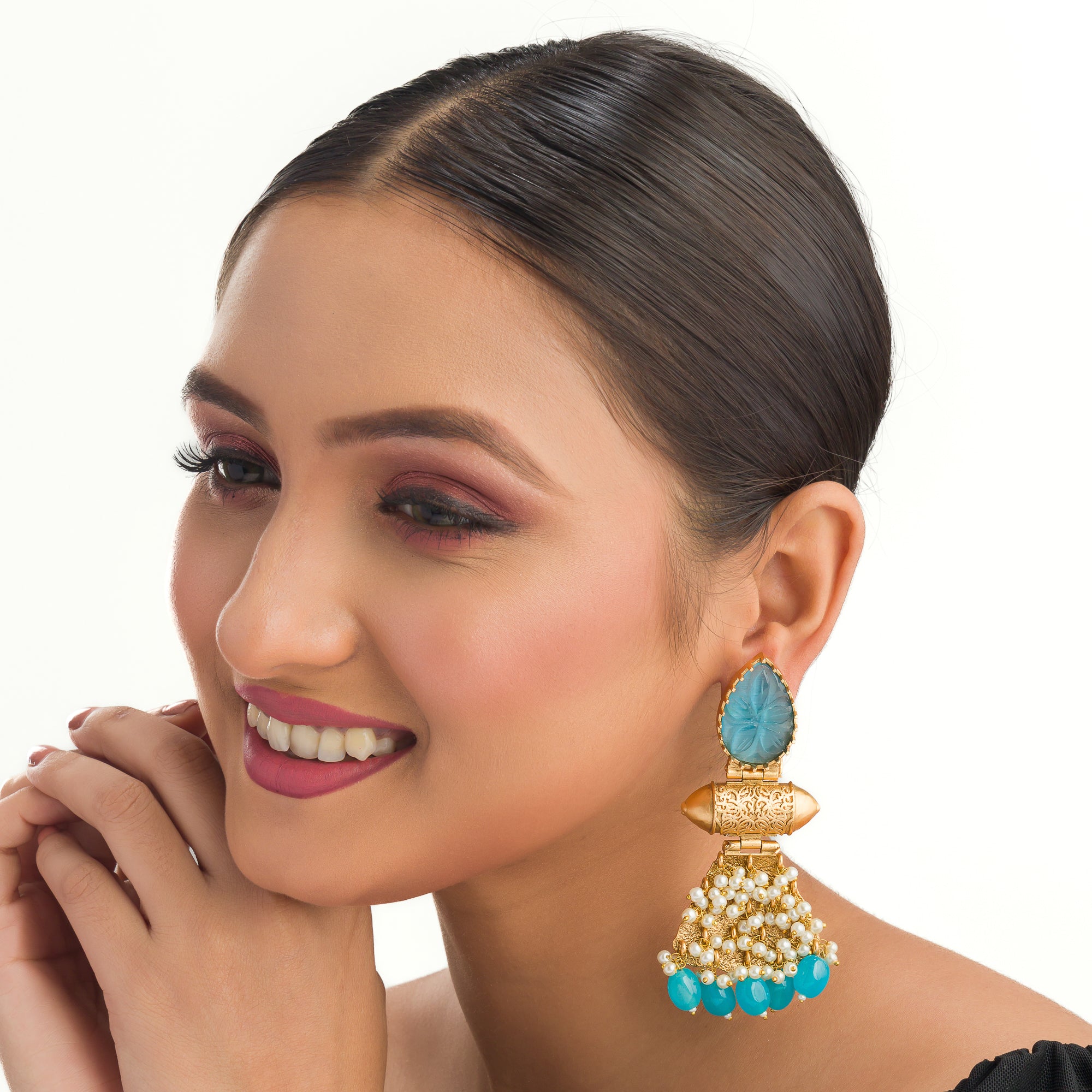"Blue earrings with gold-tone polish combine vibrant color and a sophisticated finish."