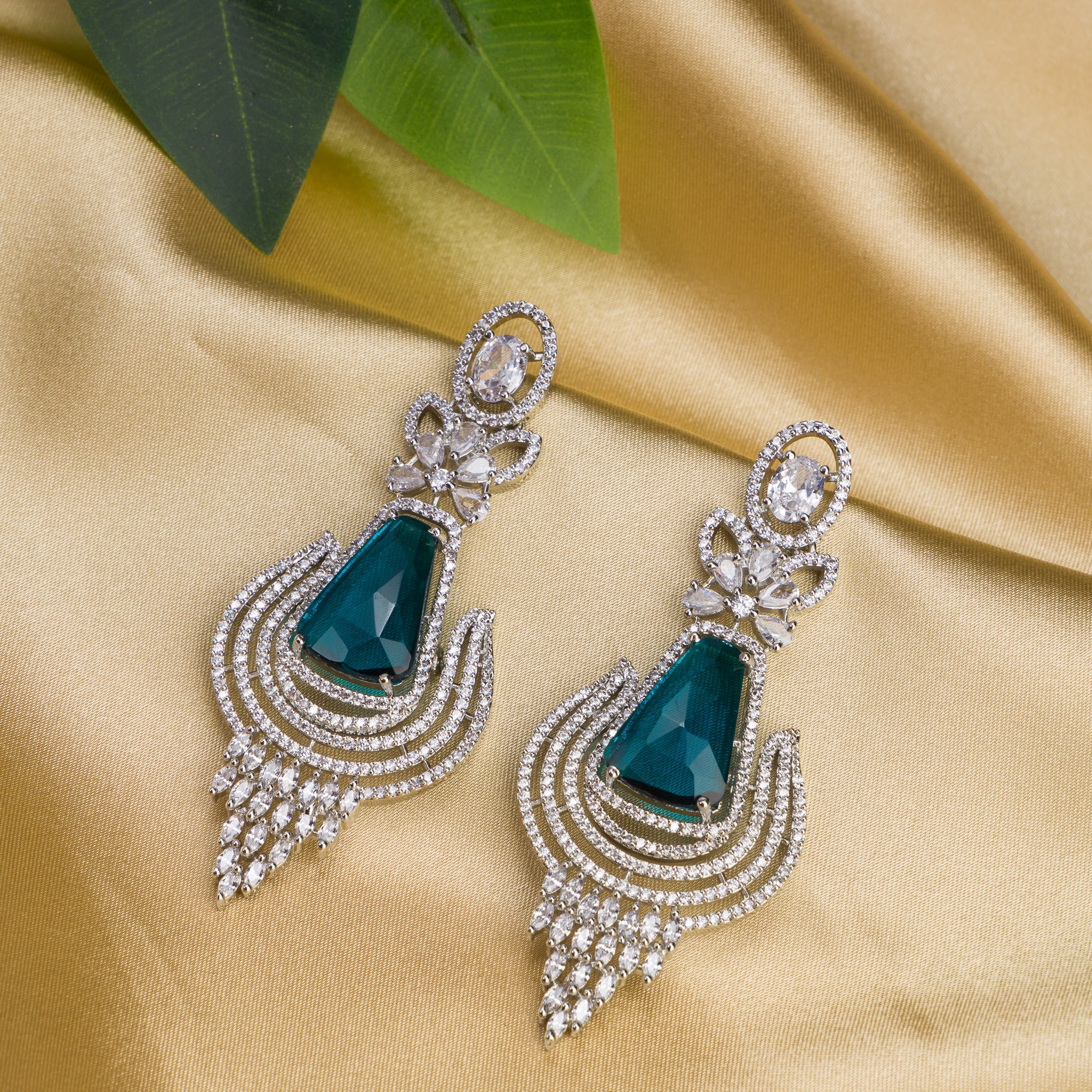 "Teal zircon earrings offer a striking, vibrant look with a touch of elegance."