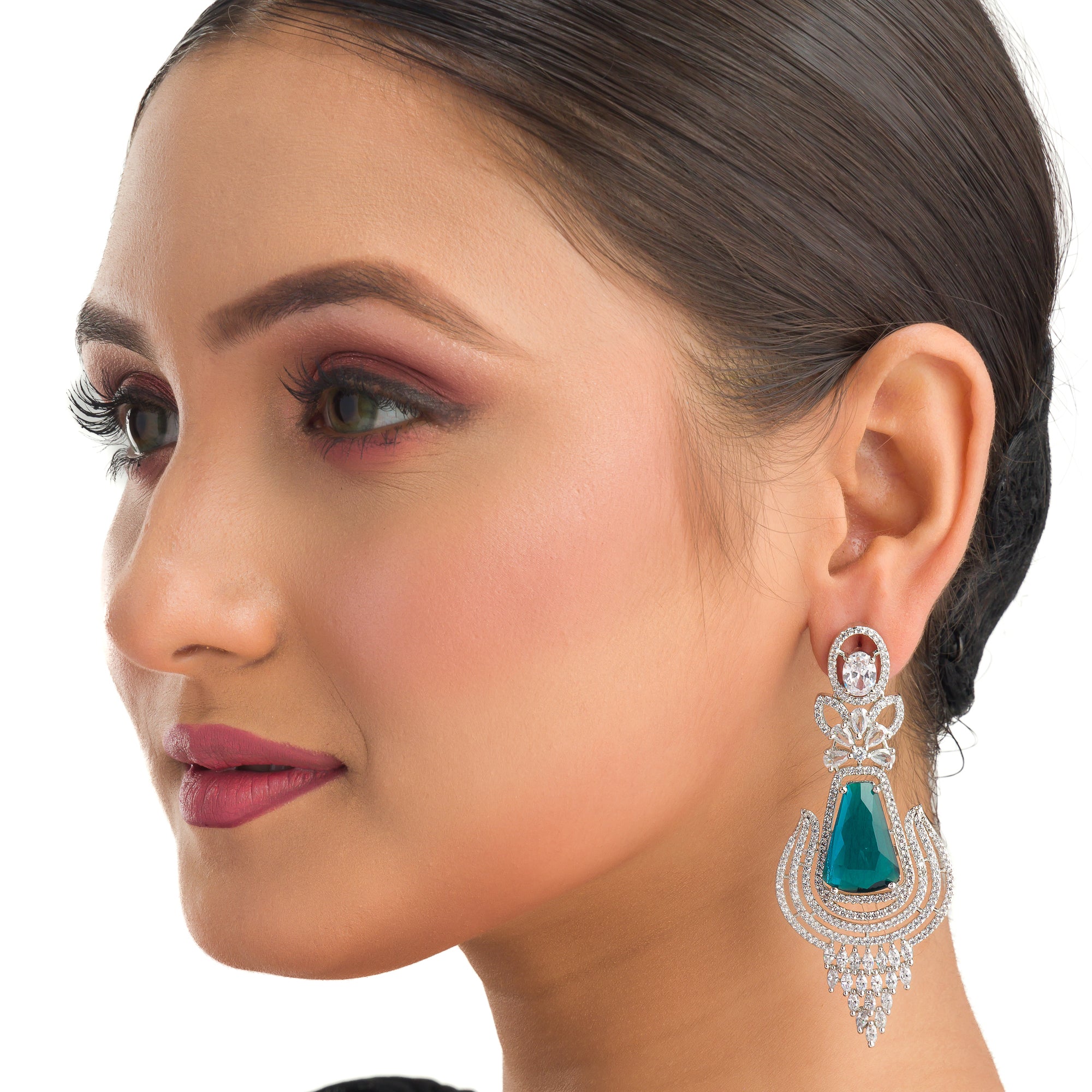 "Teal zircon earrings offer a striking, vibrant look with a touch of elegance."