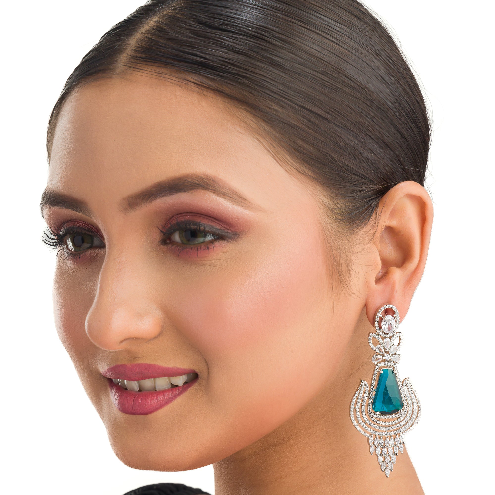 "Teal zircon earrings offer a striking, vibrant look with a touch of elegance."