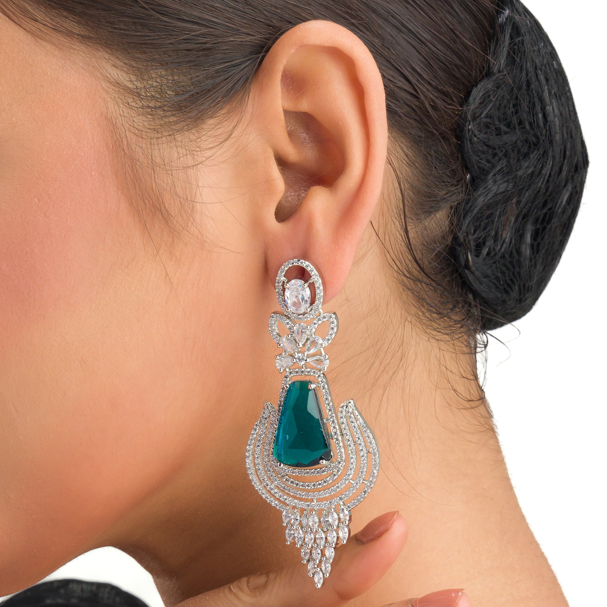 "Teal zircon earrings offer a striking, vibrant look with a touch of elegance."