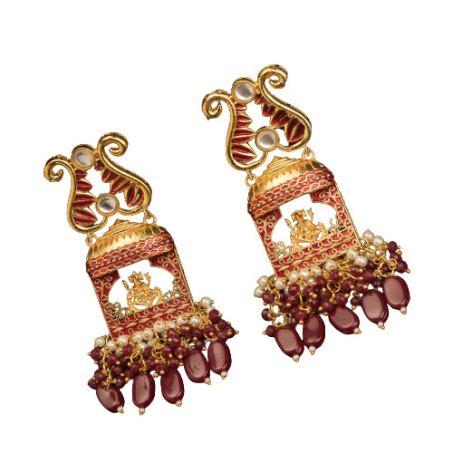 "Ganesh idol earrings with kundan and gold-tone polish add classic charm and grace."