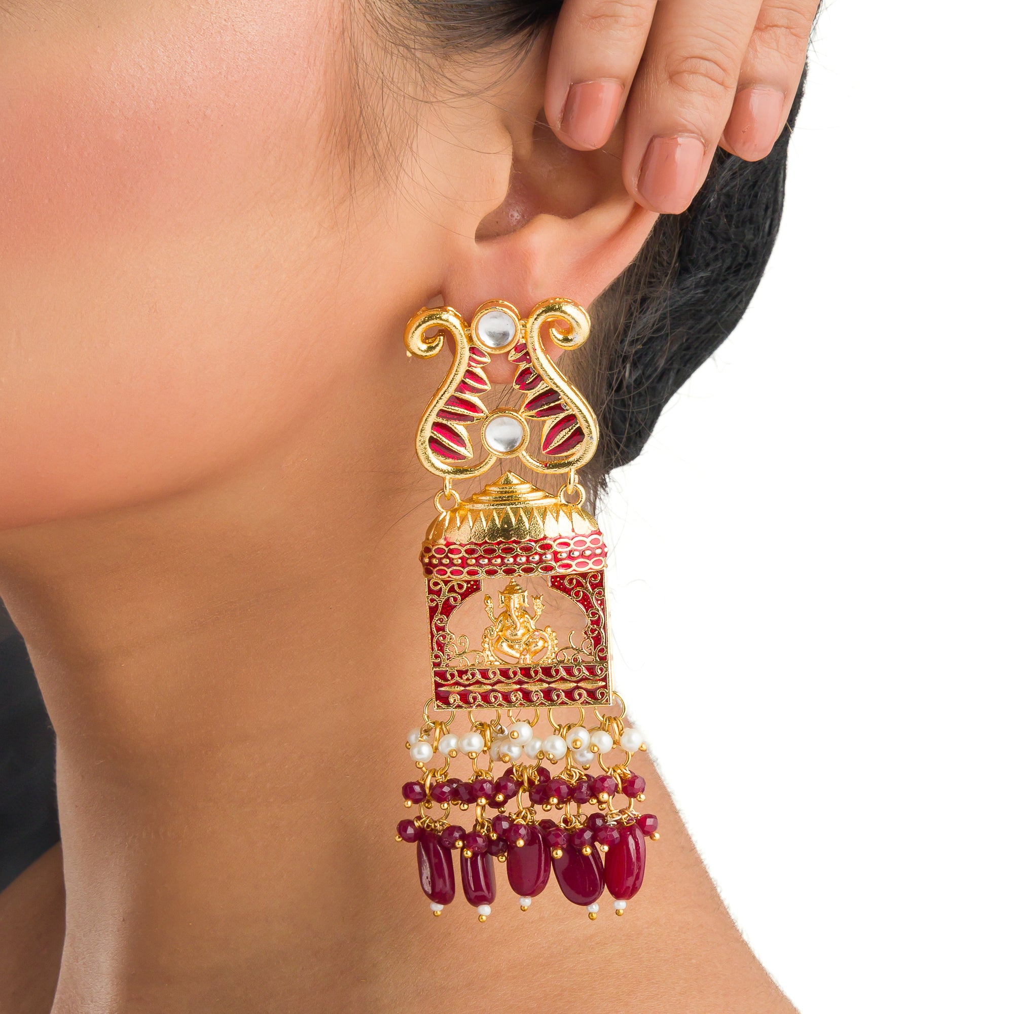 "Ganesh idol earrings with kundan and gold-tone polish add classic charm and grace."