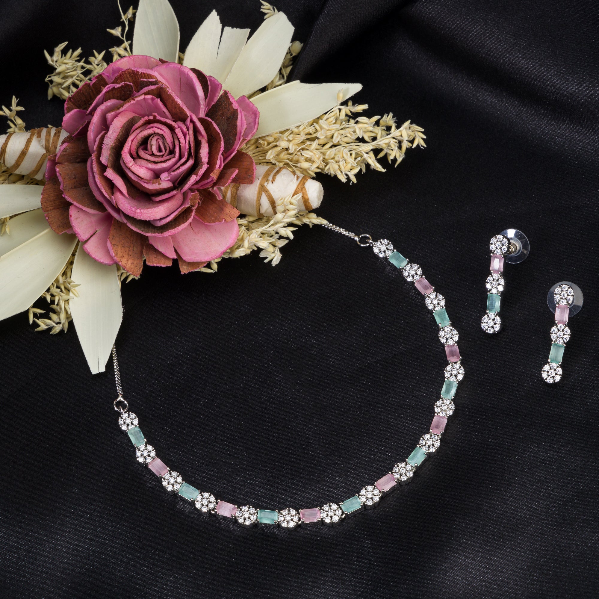"Zircon silver necklace with pink and green accents adds a delicate, colorful touch."