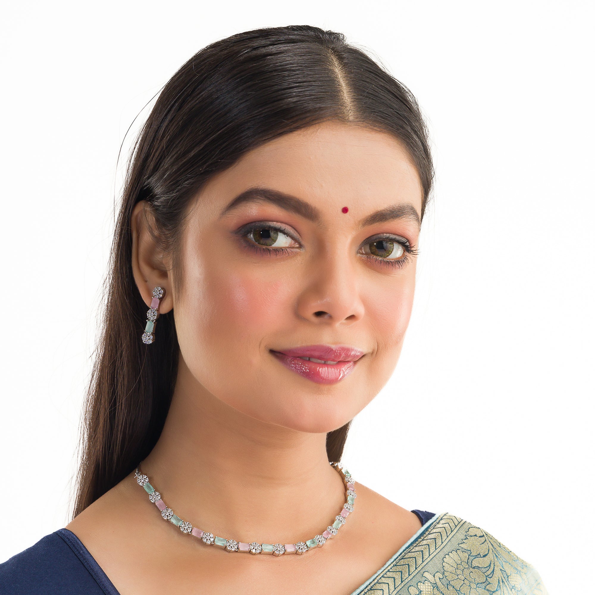 "Zircon silver necklace with pink and green accents adds a delicate, colorful touch."