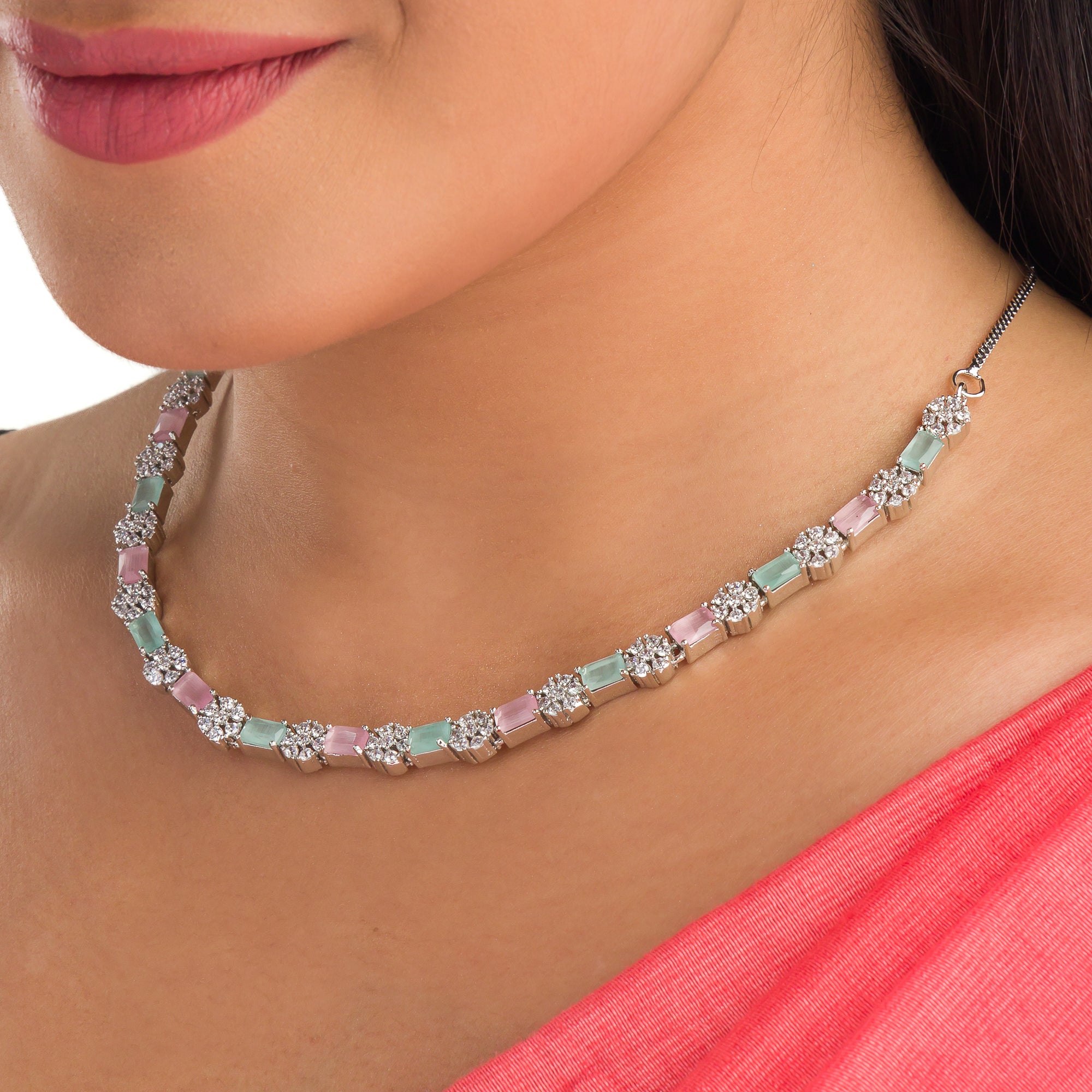"Zircon silver necklace with pink and green accents adds a delicate, colorful touch."