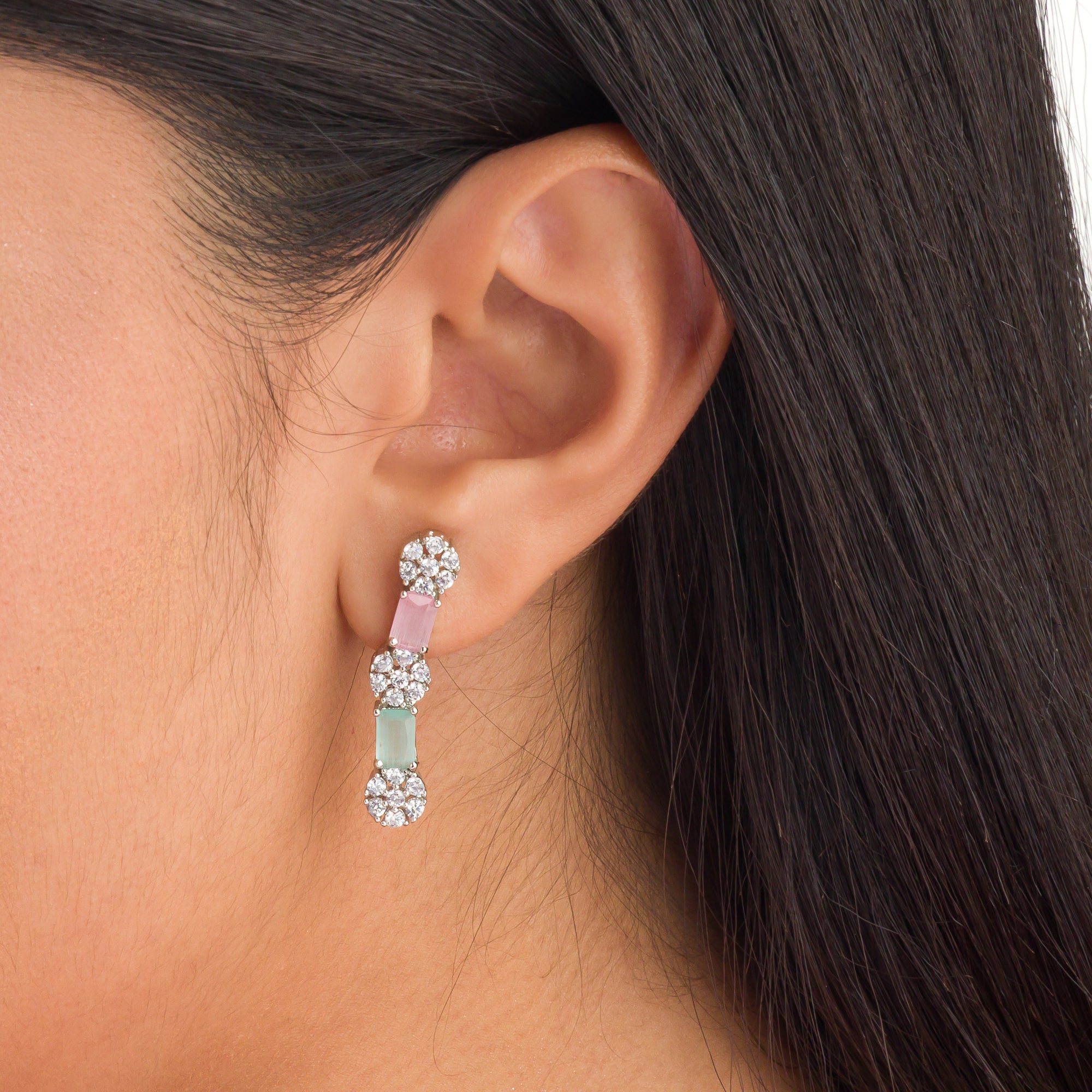 "Zircon silver necklace with pink and green accents adds a delicate, colorful touch."