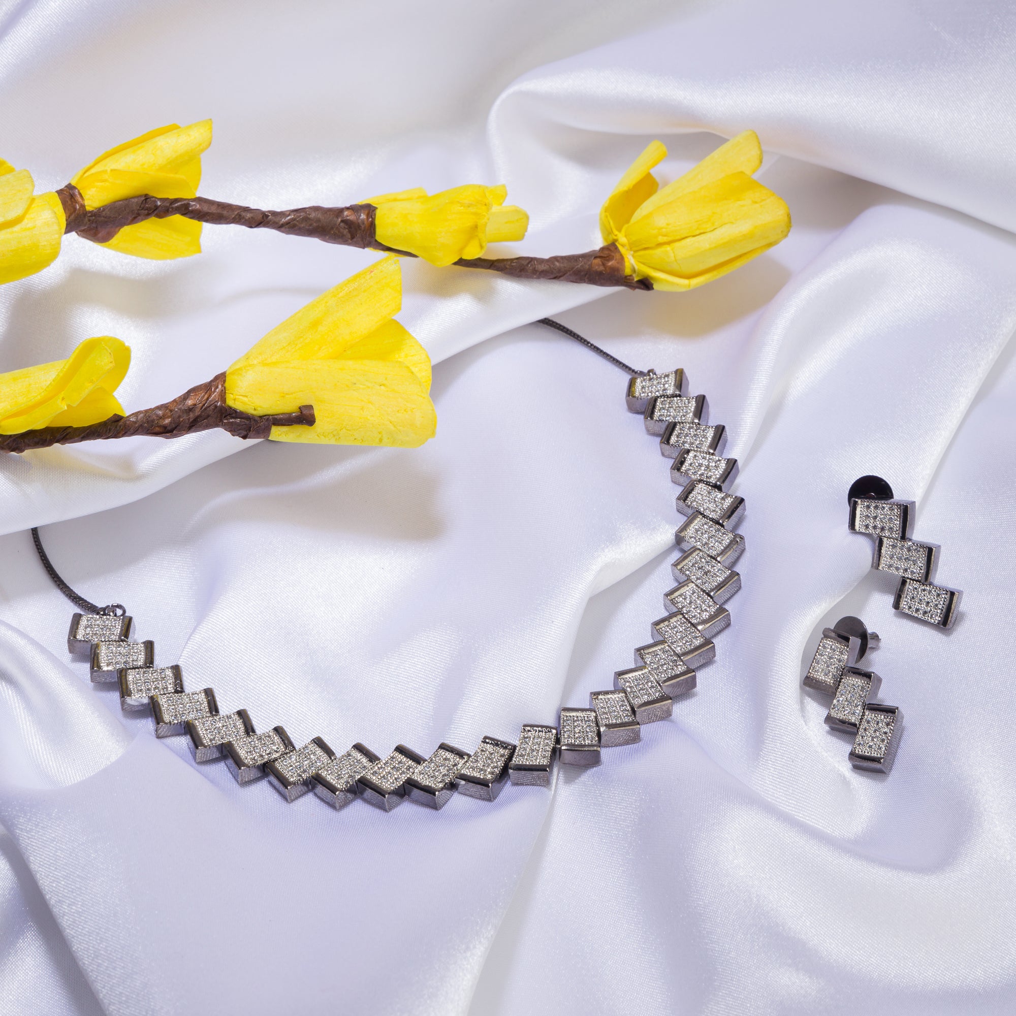 "Zigzag-shaped zircon necklace adds a modern twist to classic sparkle."