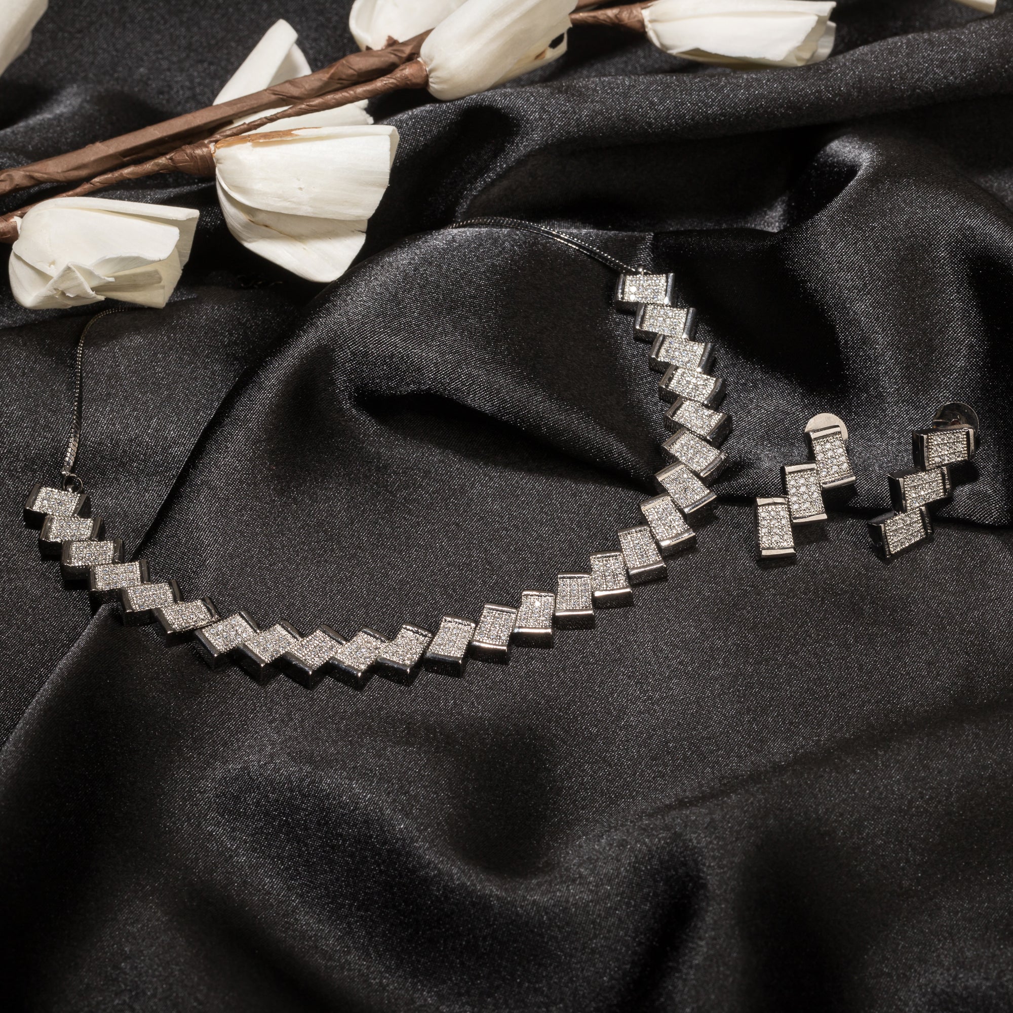 "Zigzag-shaped zircon necklace adds a modern twist to classic sparkle."