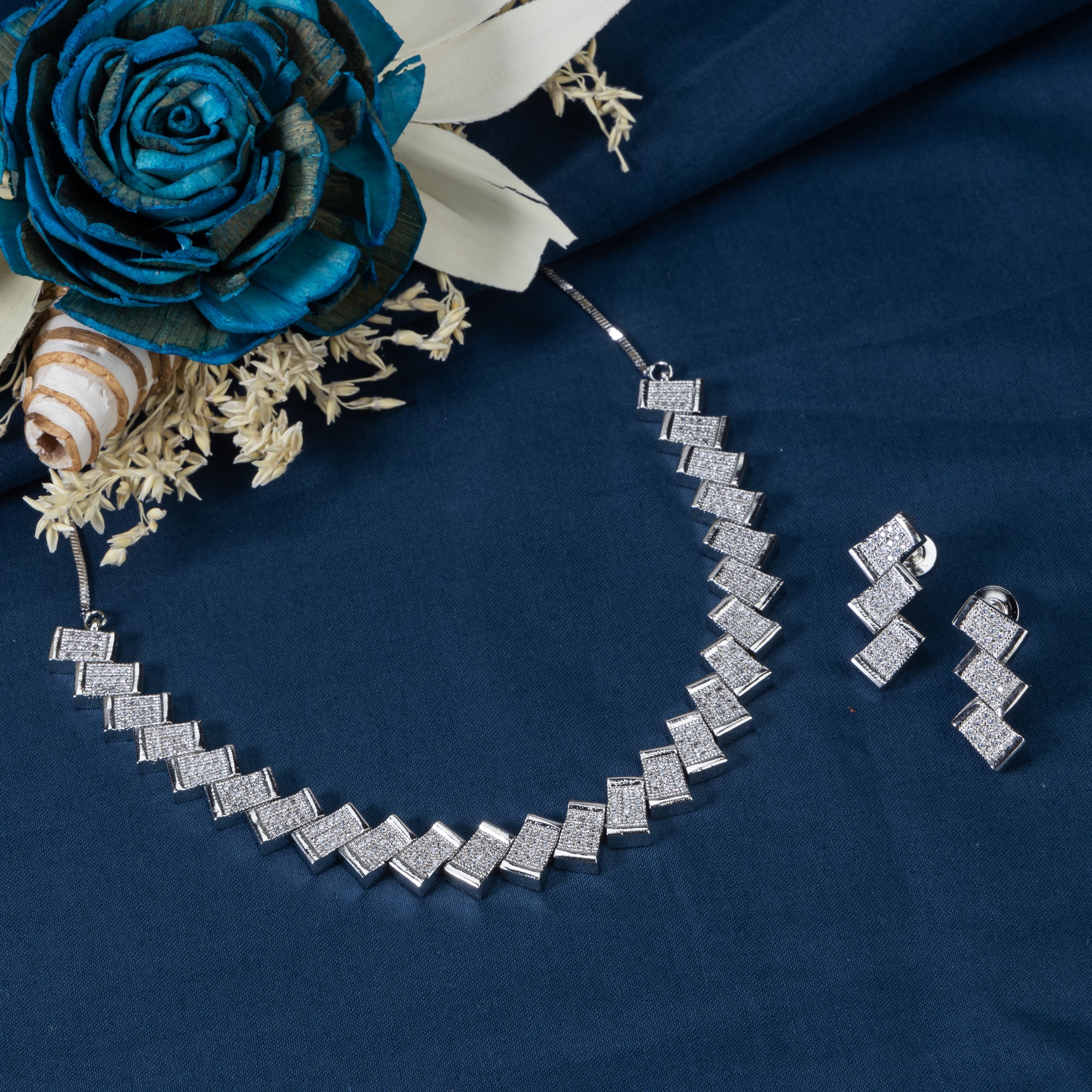 "Zigzag-shaped zircon necklace adds a modern twist to classic sparkle."