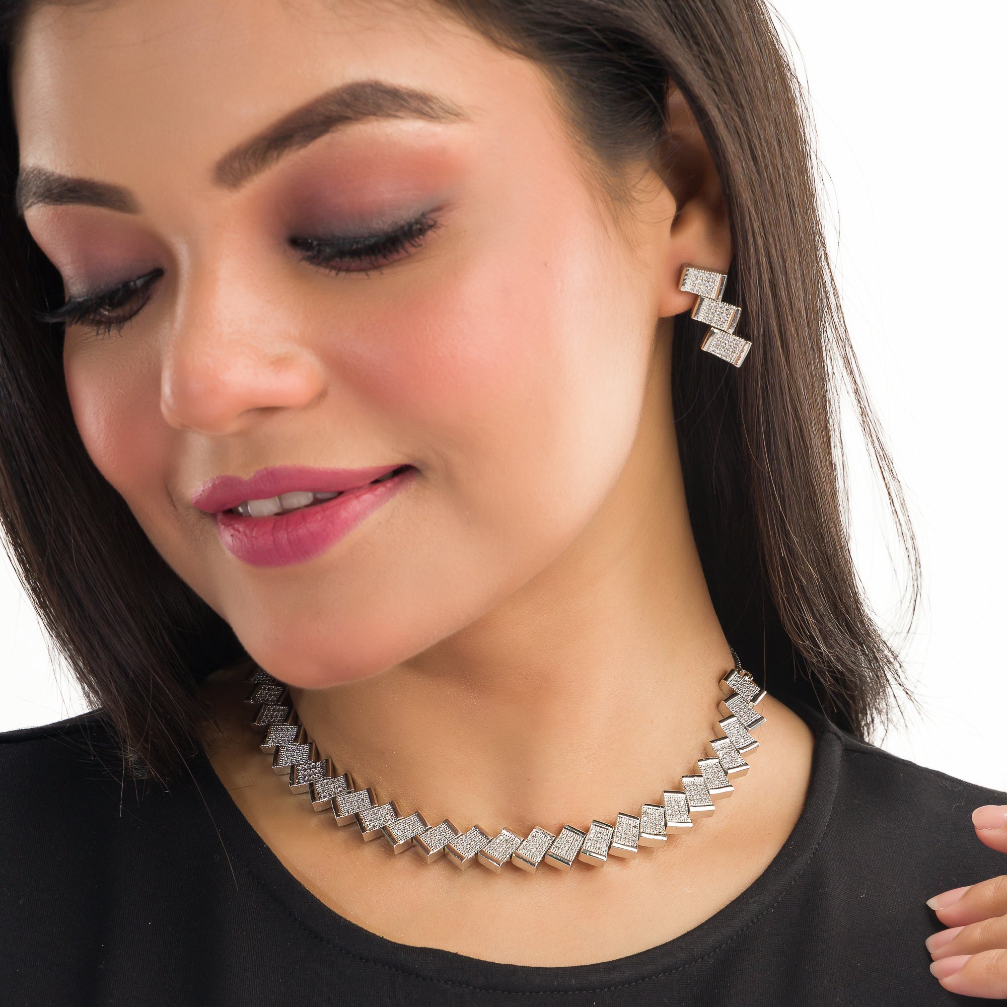 "Zigzag-shaped zircon necklace adds a modern twist to classic sparkle."