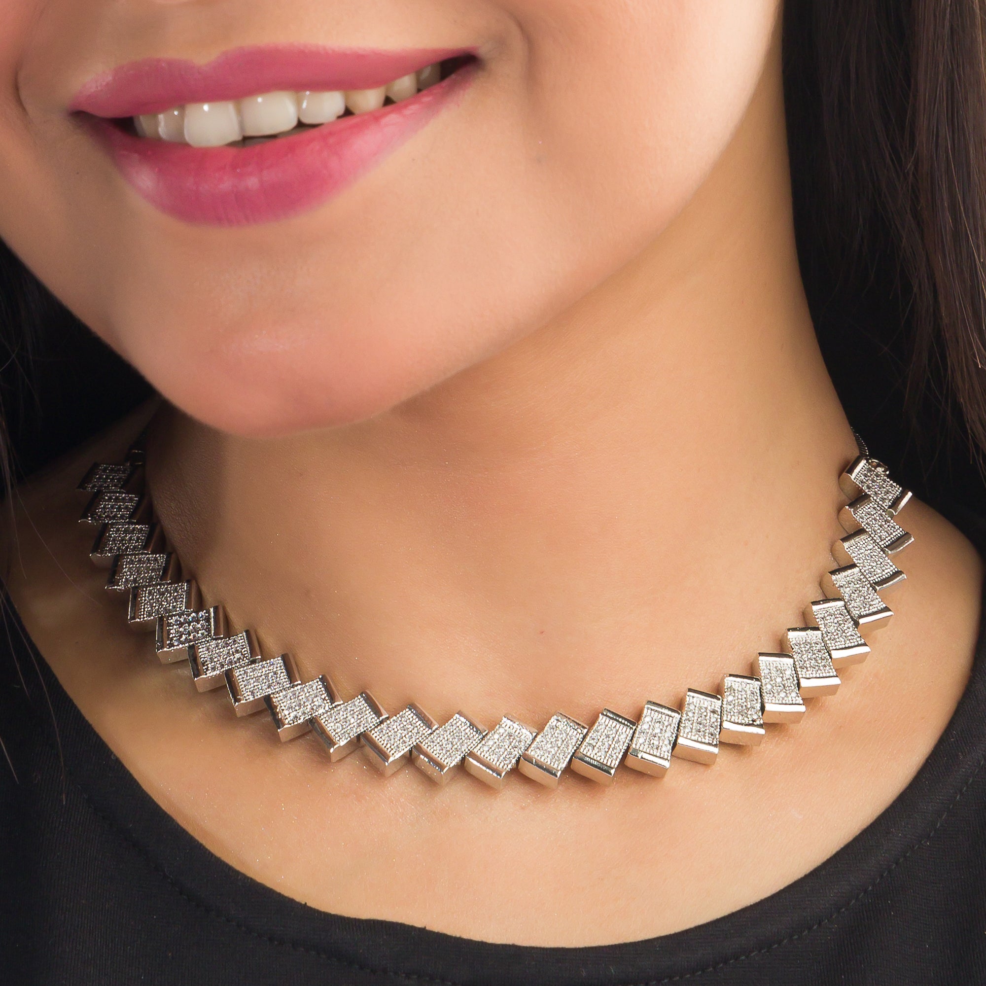 "Zigzag-shaped zircon necklace adds a modern twist to classic sparkle."