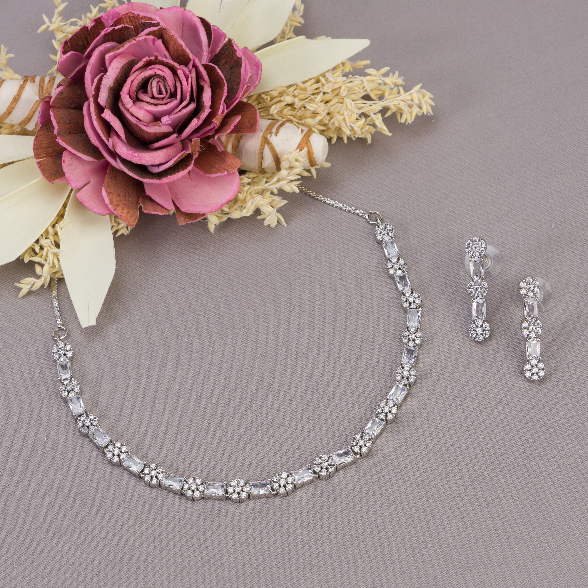 "Delicate zircon necklace with small flower design adds elegance and sparkle."
