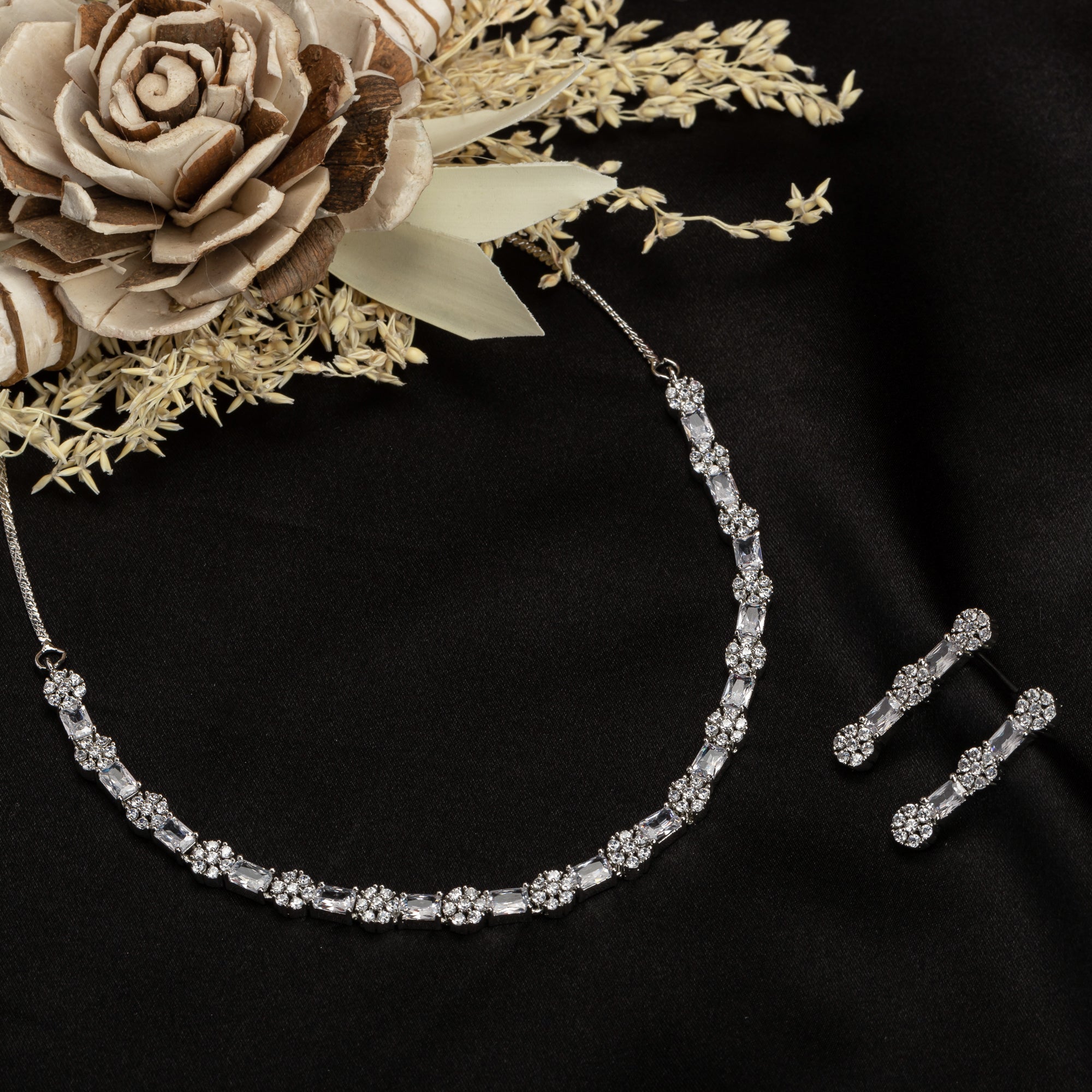 "Delicate zircon necklace with small flower design adds elegance and sparkle."