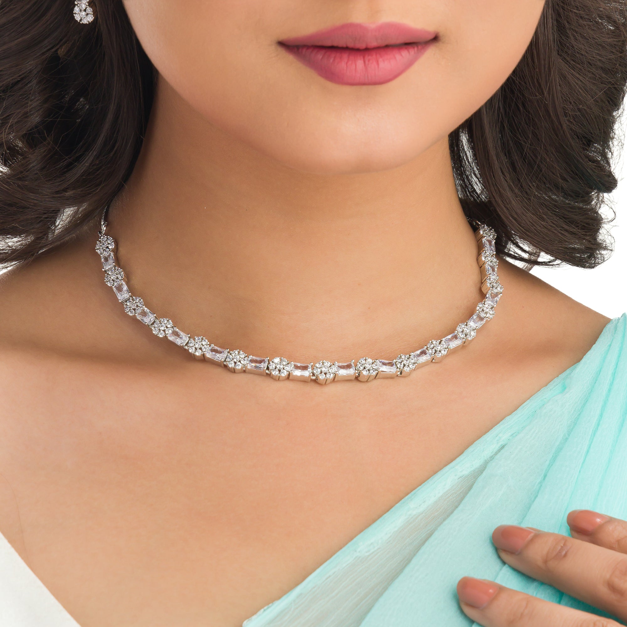 "Delicate zircon necklace with small flower design adds elegance and sparkle."