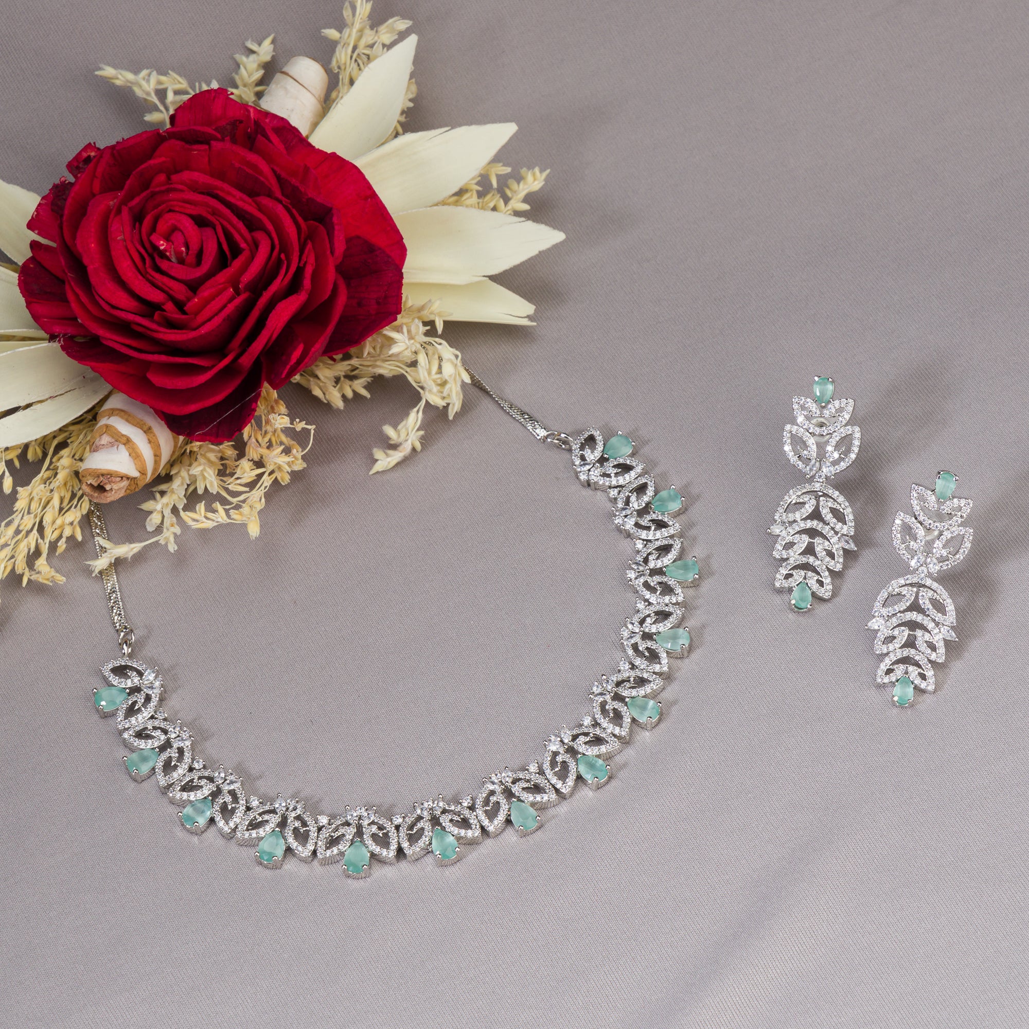 "Light green zircon necklace with leaf pattern adds subtle charm."