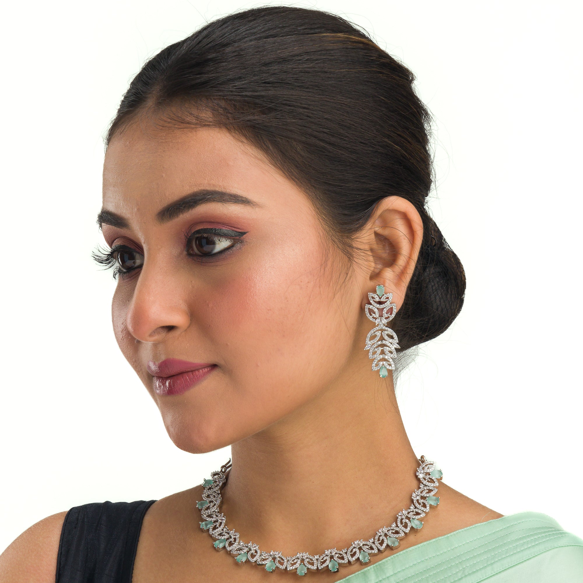 "Light green zircon necklace with leaf pattern adds subtle charm."