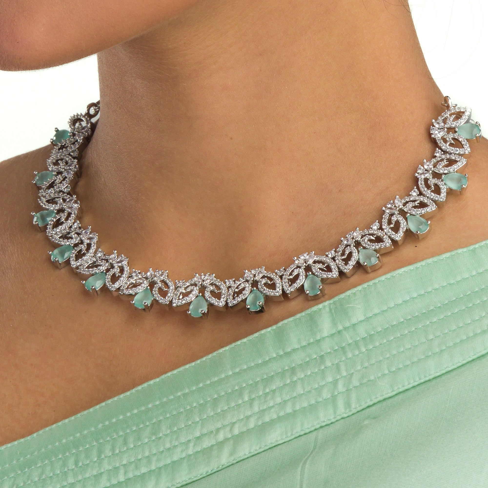 "Light green zircon necklace with leaf pattern adds subtle charm."