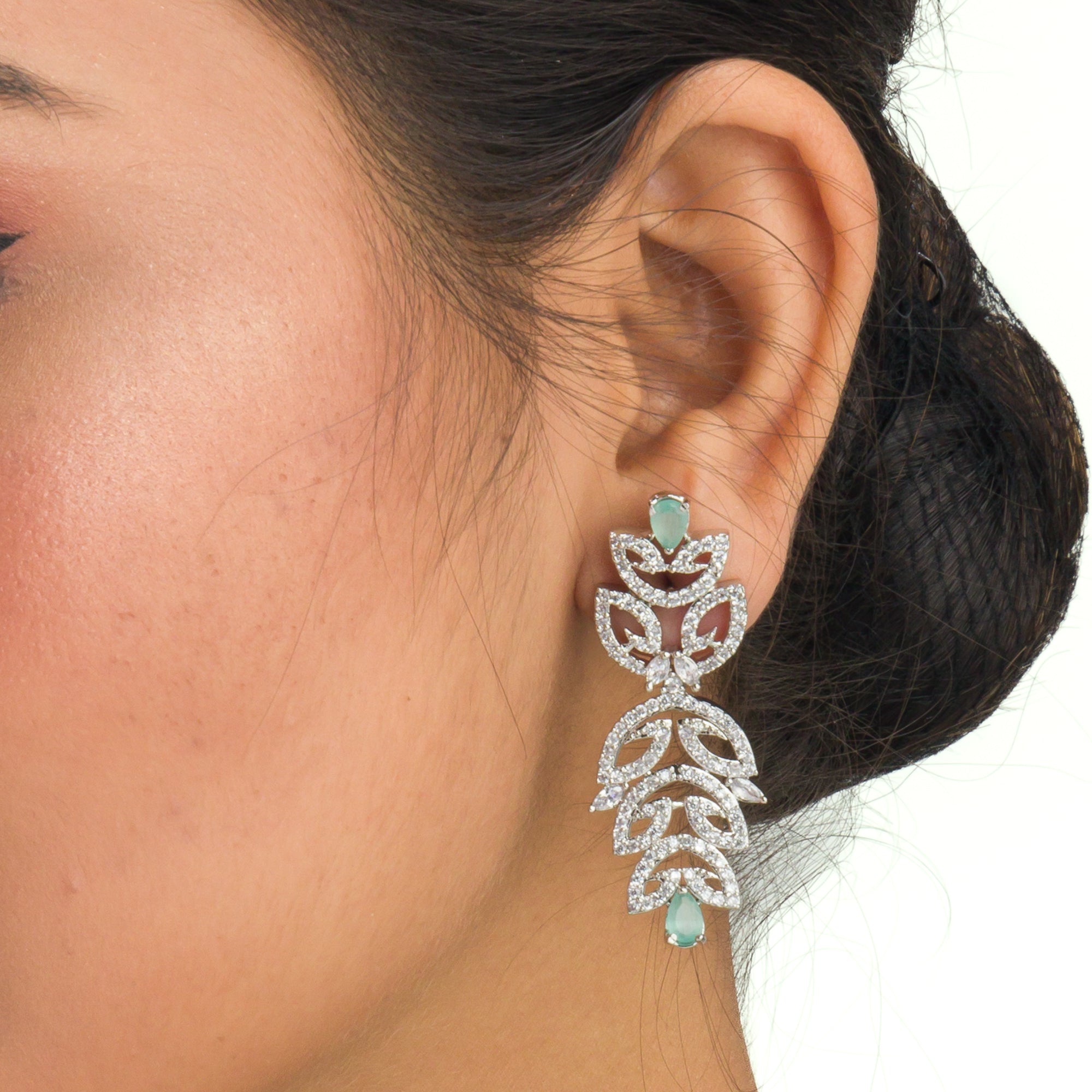 "Light green zircon necklace with leaf pattern adds subtle charm."