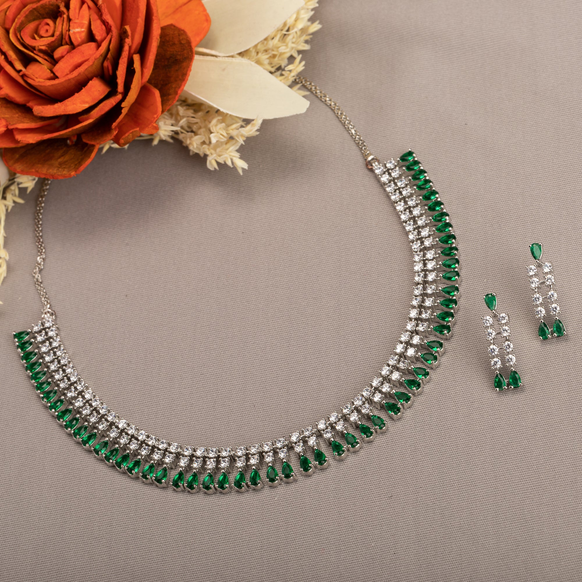 "Zircon necklace with white and green stones adds a vibrant, elegant touch."