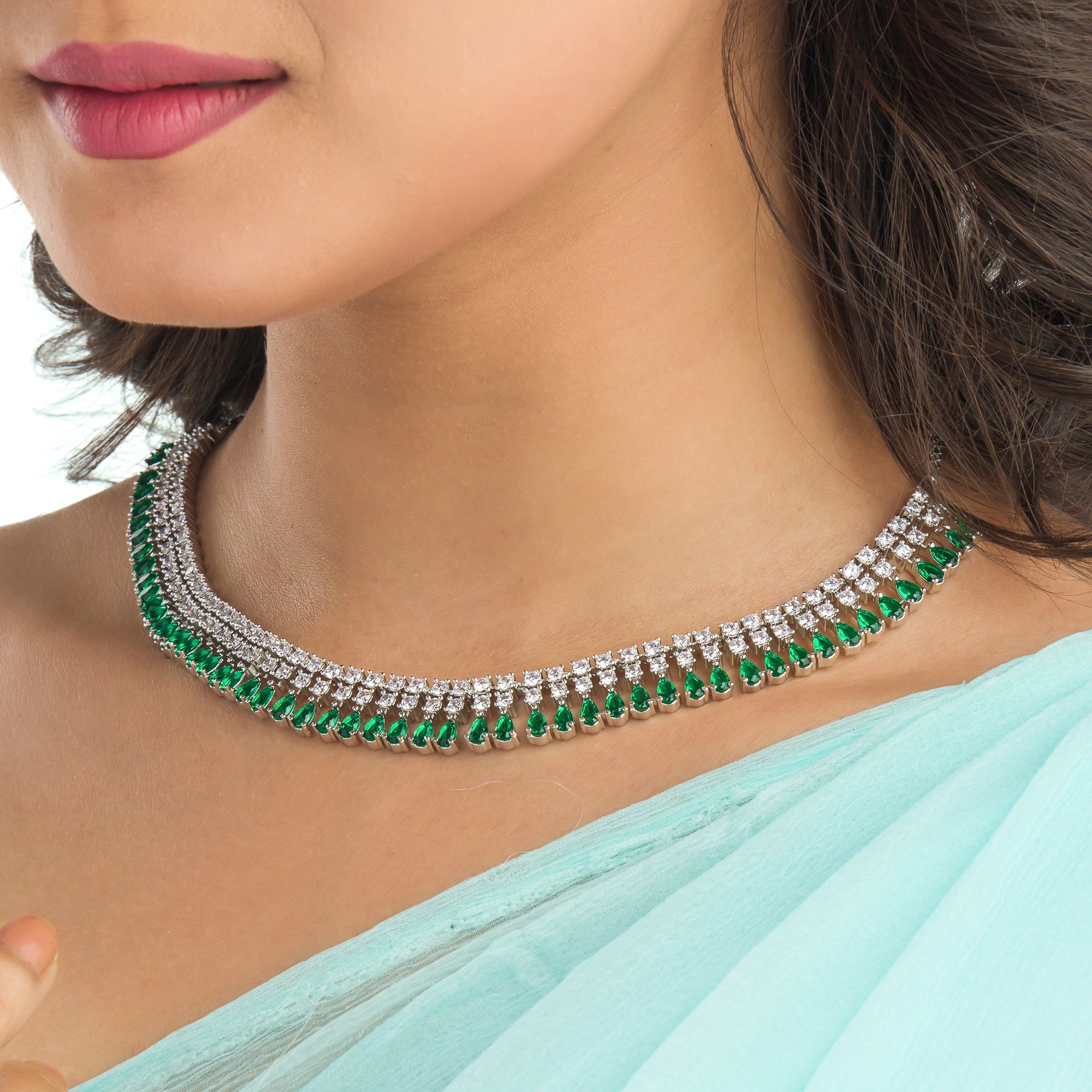 "Zircon necklace with white and green stones adds a vibrant, elegant touch."