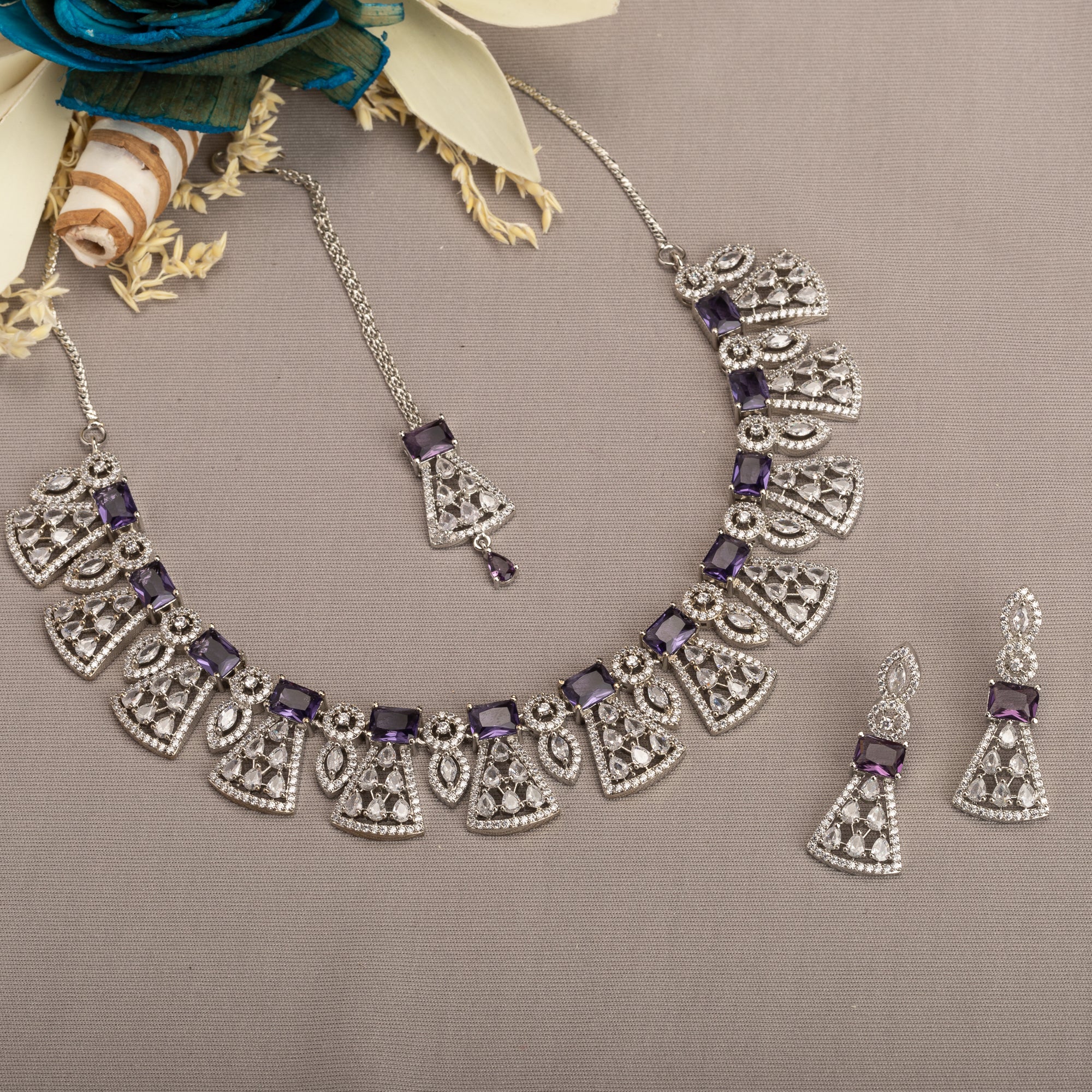 "Navy blue zircon necklace set with maang tikka exudes elegant coordination and style."
