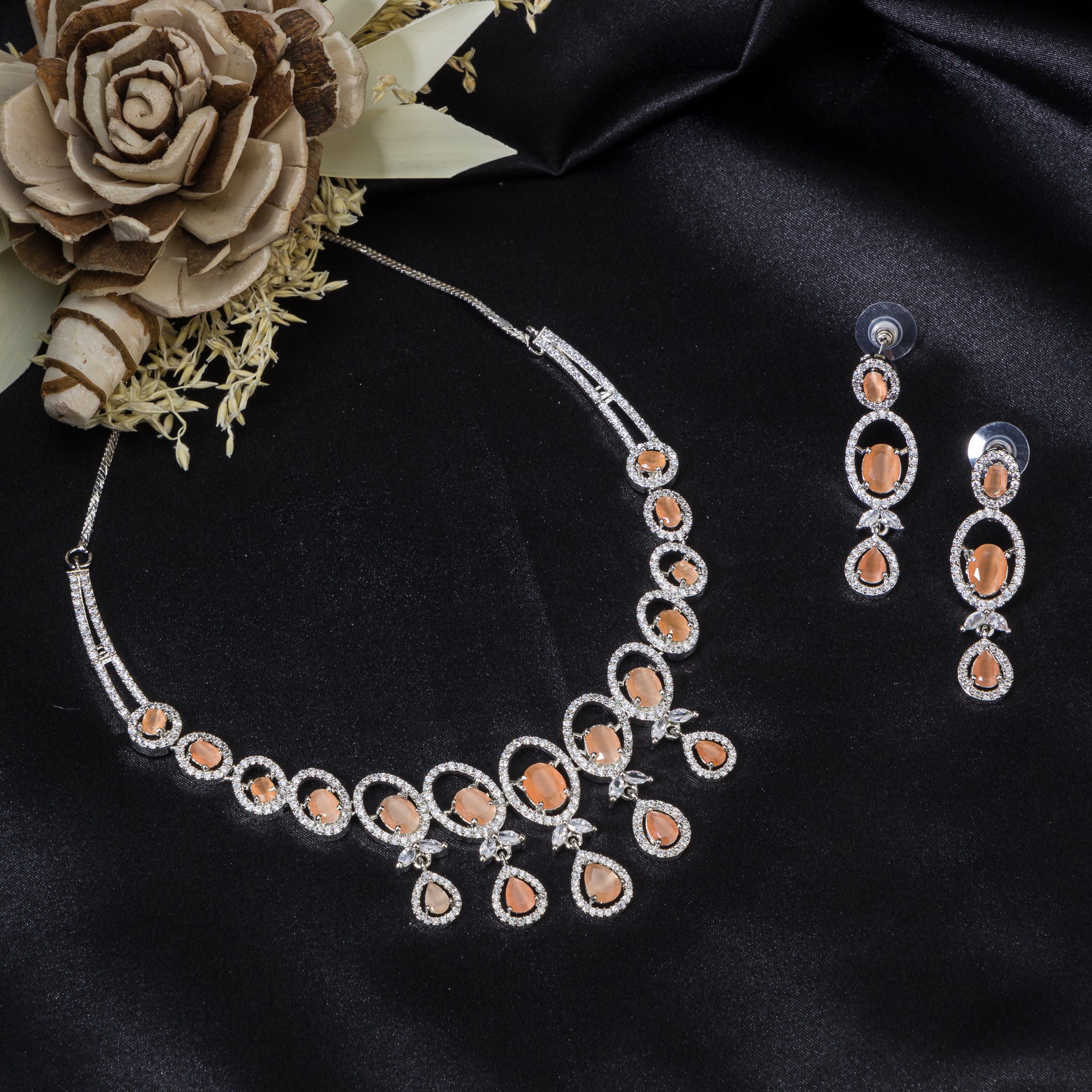 "Salmon zircon necklace with white zircons adds vibrant sparkle for a lively, chic look."