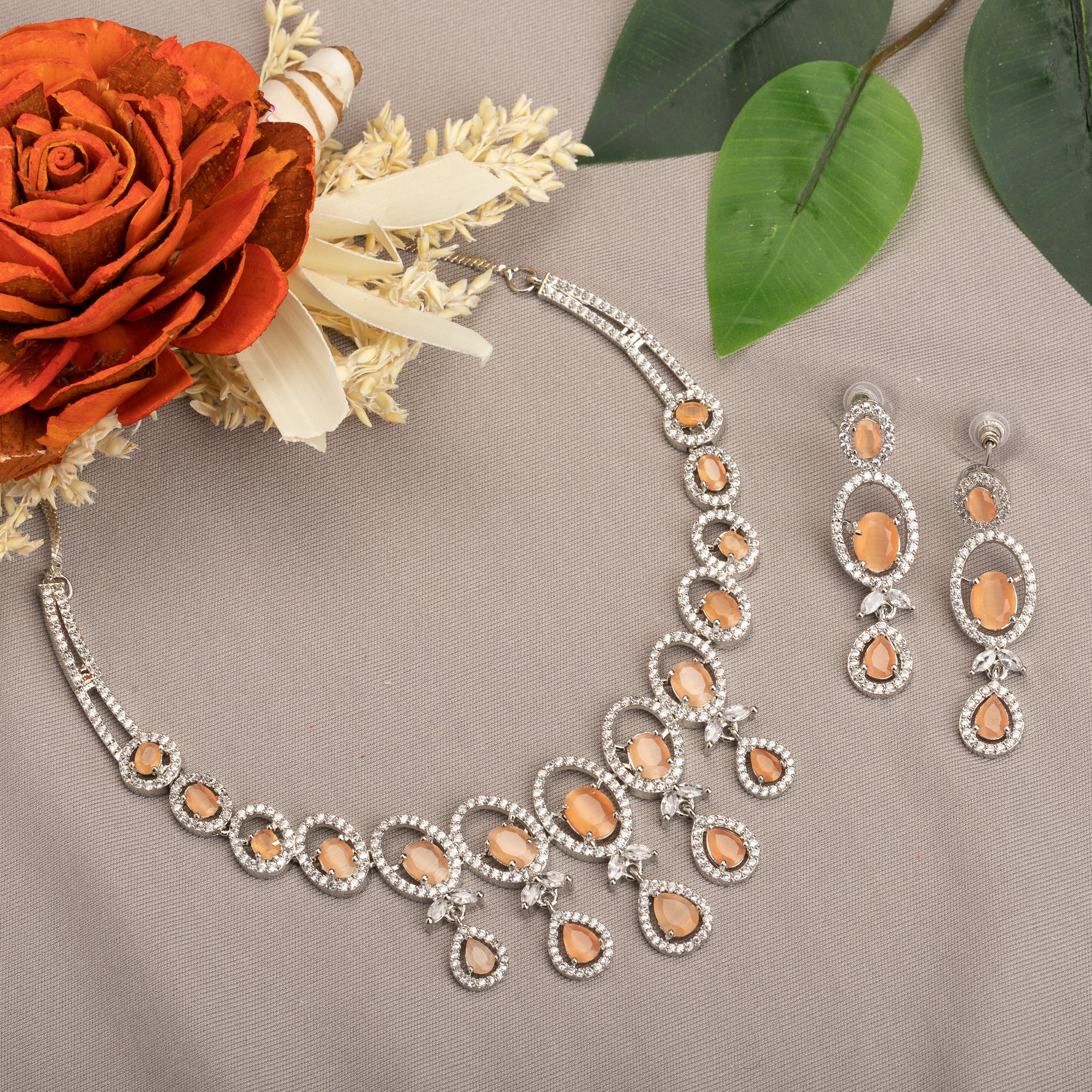 "Salmon zircon necklace with white zircons adds vibrant sparkle for a lively, chic look."