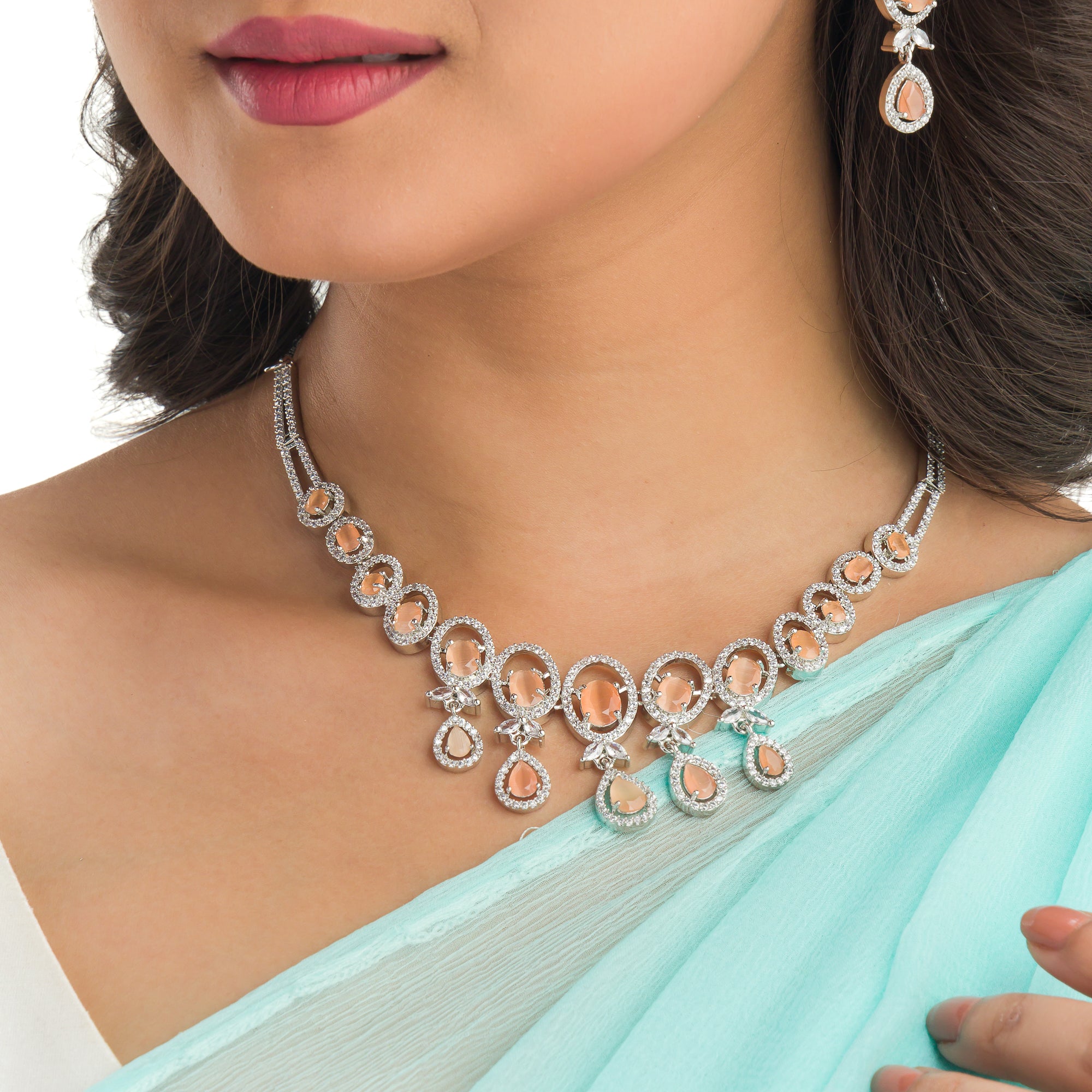 "Salmon zircon necklace with white zircons adds vibrant sparkle for a lively, chic look."