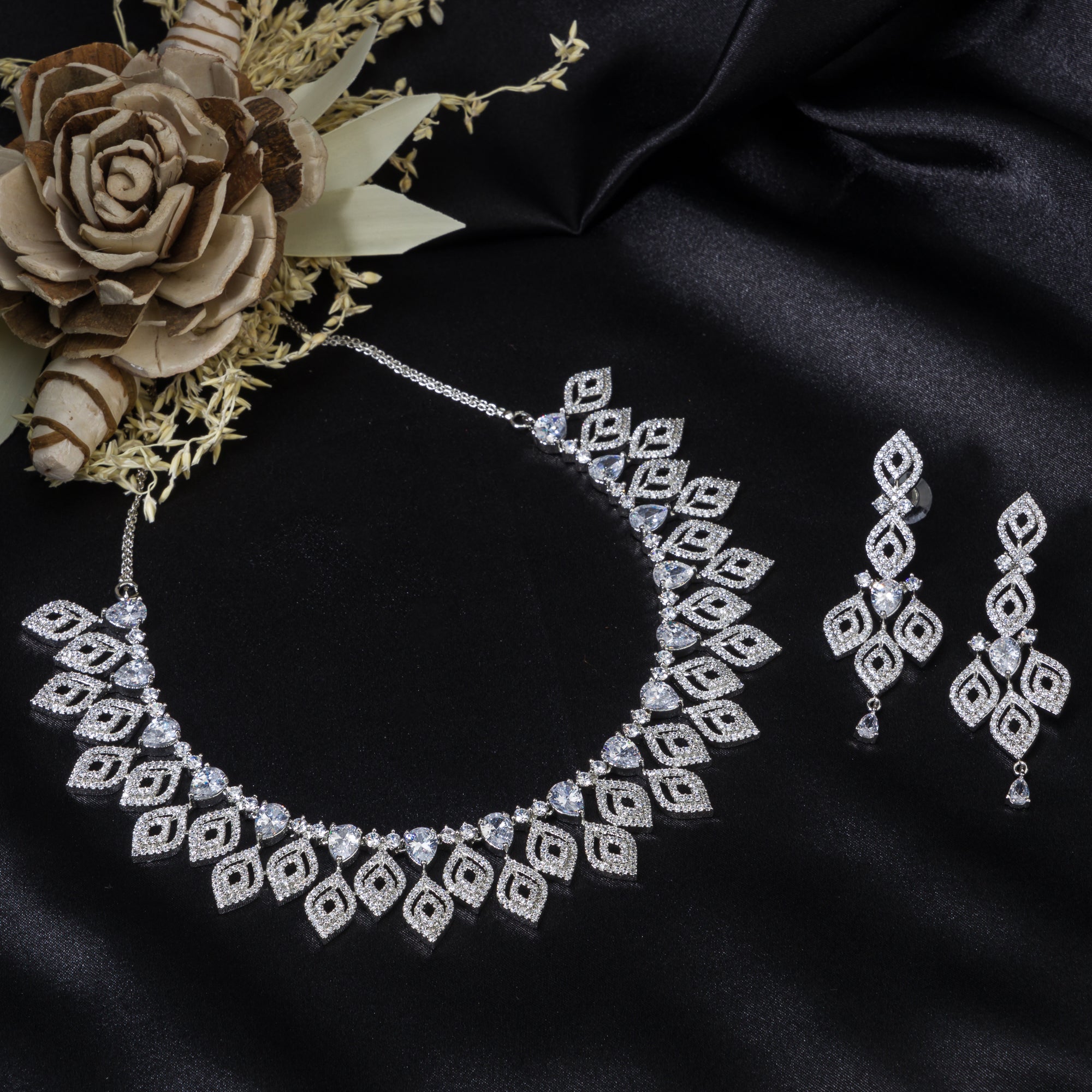 "Silver zircon necklace with leaf motifs adds natural elegance and sophisticated charm."
