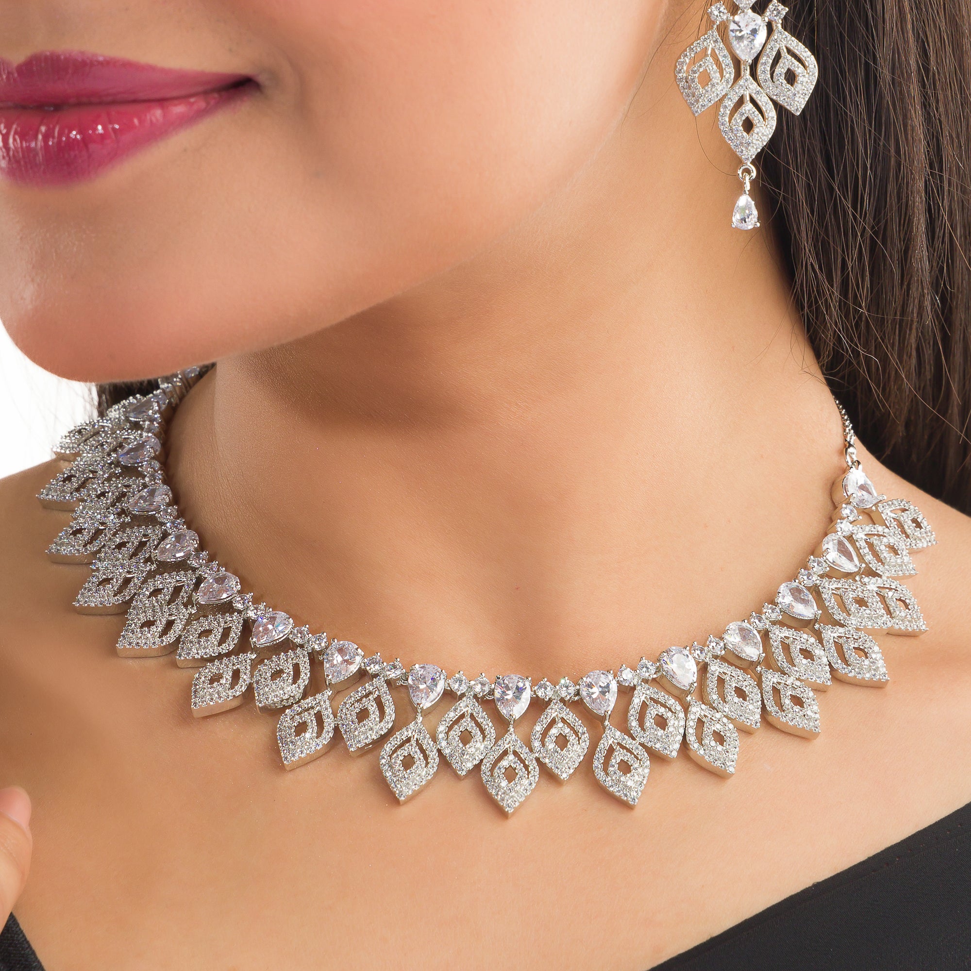 "Silver zircon necklace with leaf motifs adds natural elegance and sophisticated charm."