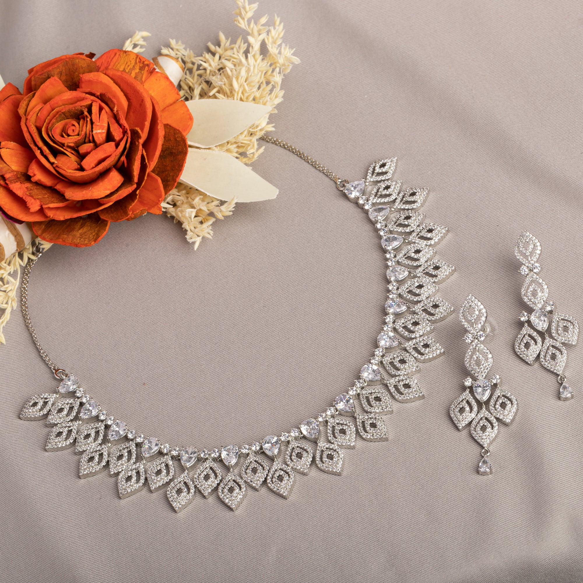 "Silver zircon necklace with leaf motifs adds natural elegance and sophisticated charm."