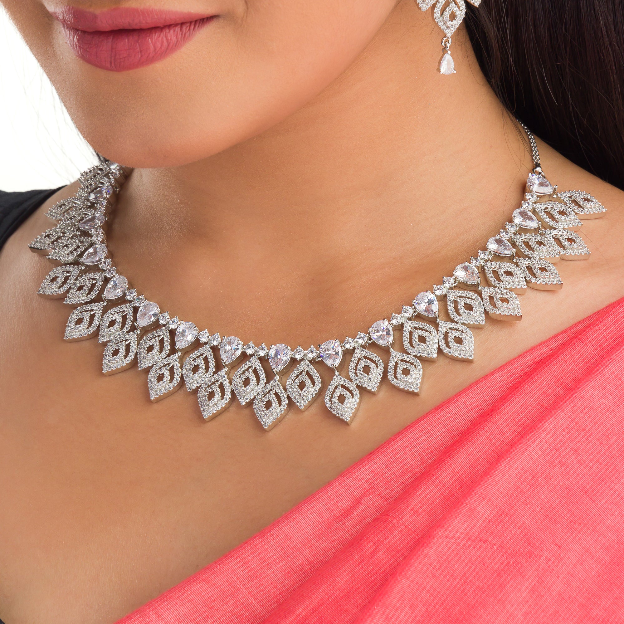 "Silver zircon necklace with leaf motifs adds natural elegance and sophisticated charm."