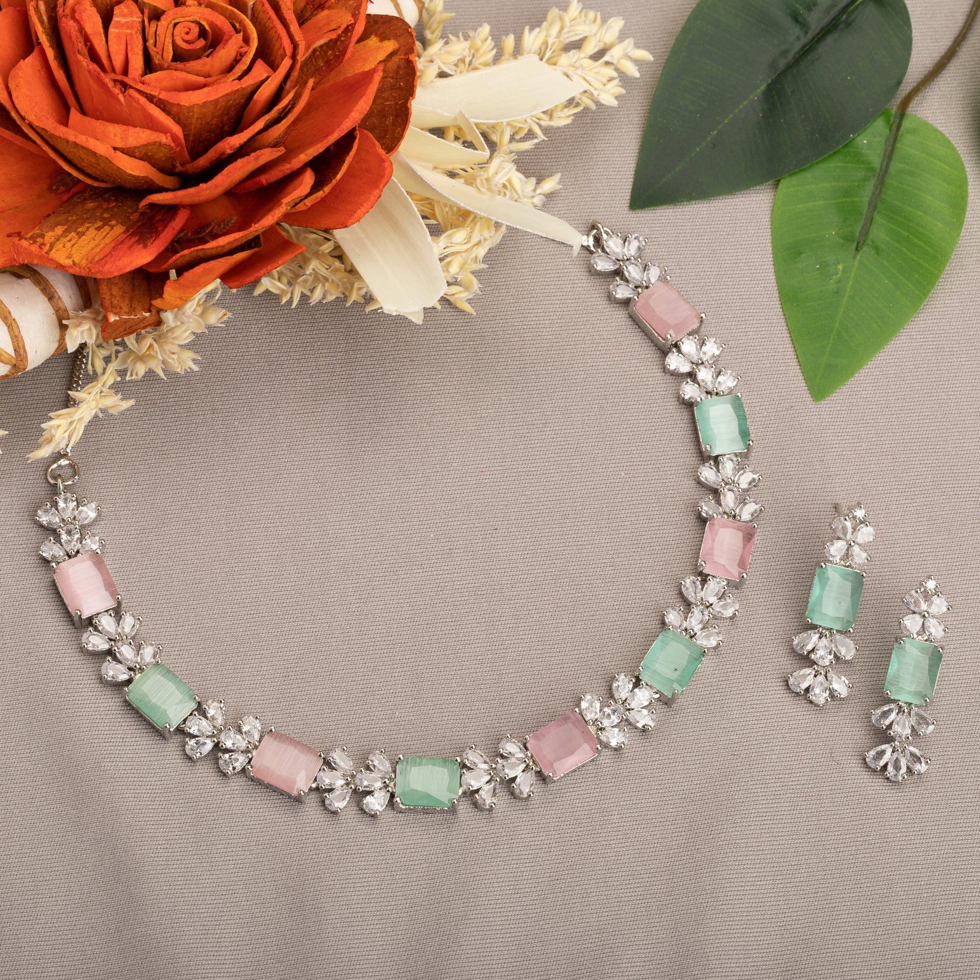"Trendy pink and green zircon necklace in square design offers chic, modern elegance."