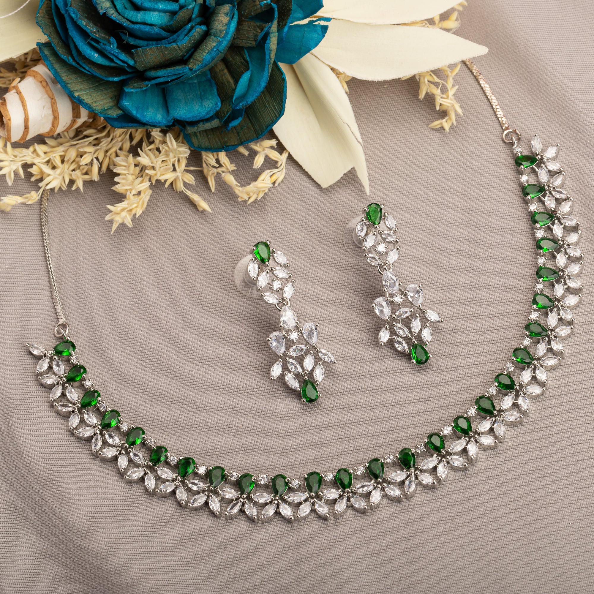 "Green and white zircon necklace in floral design adds vibrant, floral elegance."