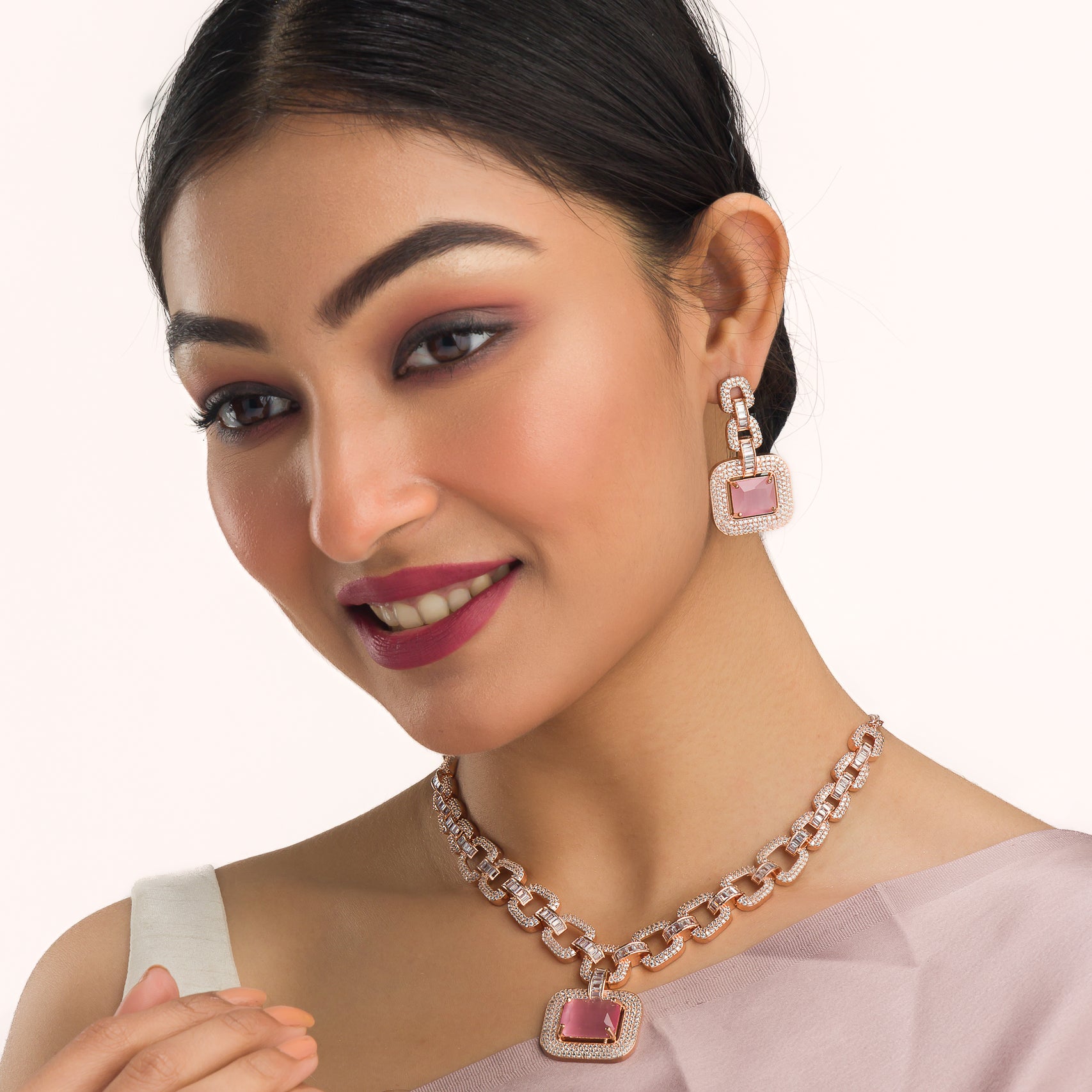 "Pink square and white zircon necklace with rose gold polish shines elegantly."